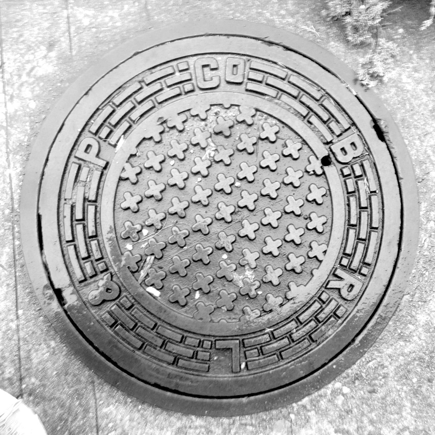 black and white image of a utility cover