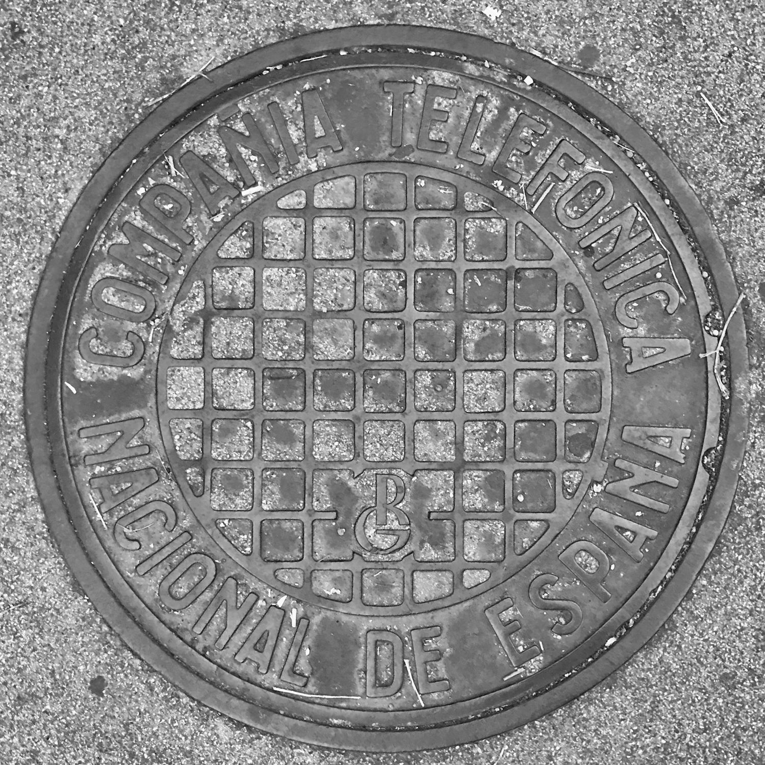 black and white image of a utility cover