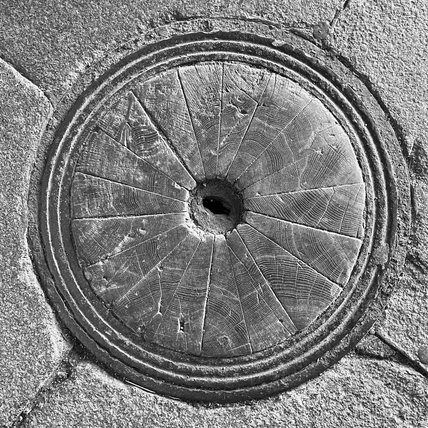 black and white image of a utility cover