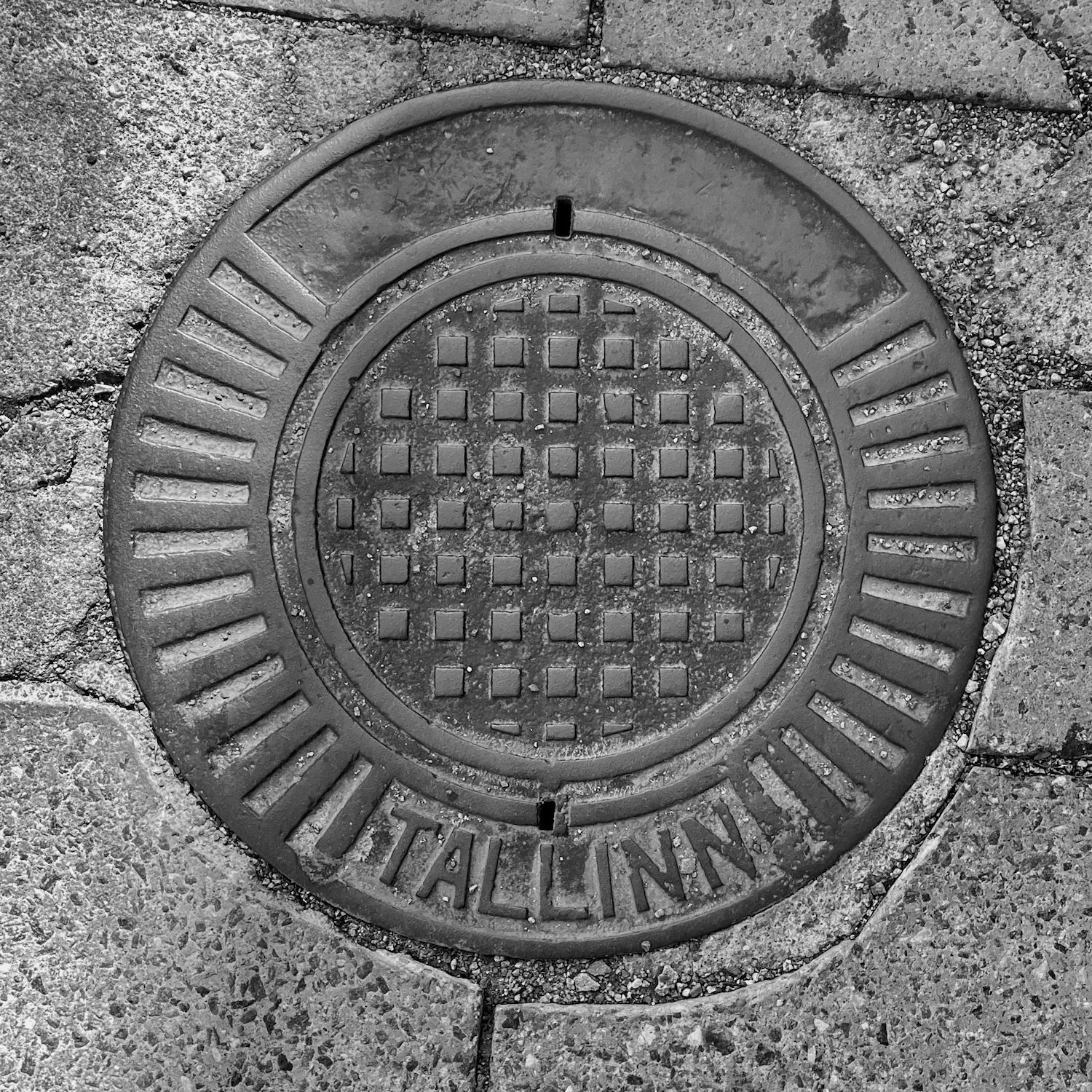 black and white image of a utility cover