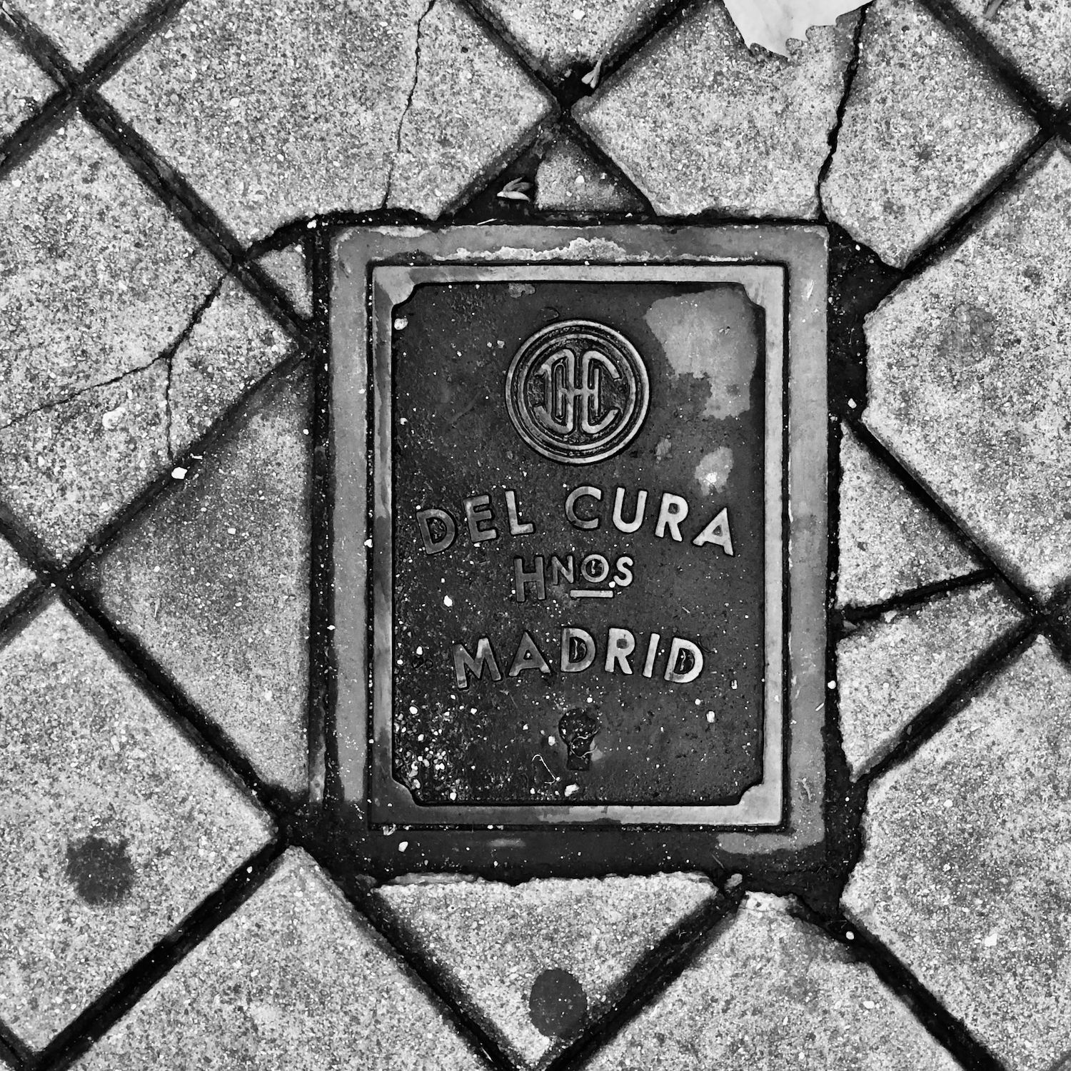 black and white image of a utility cover
