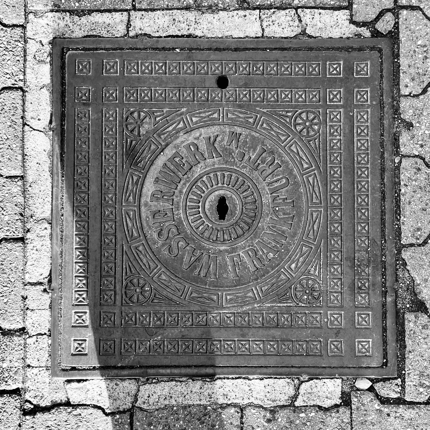 black and white image of a utility cover