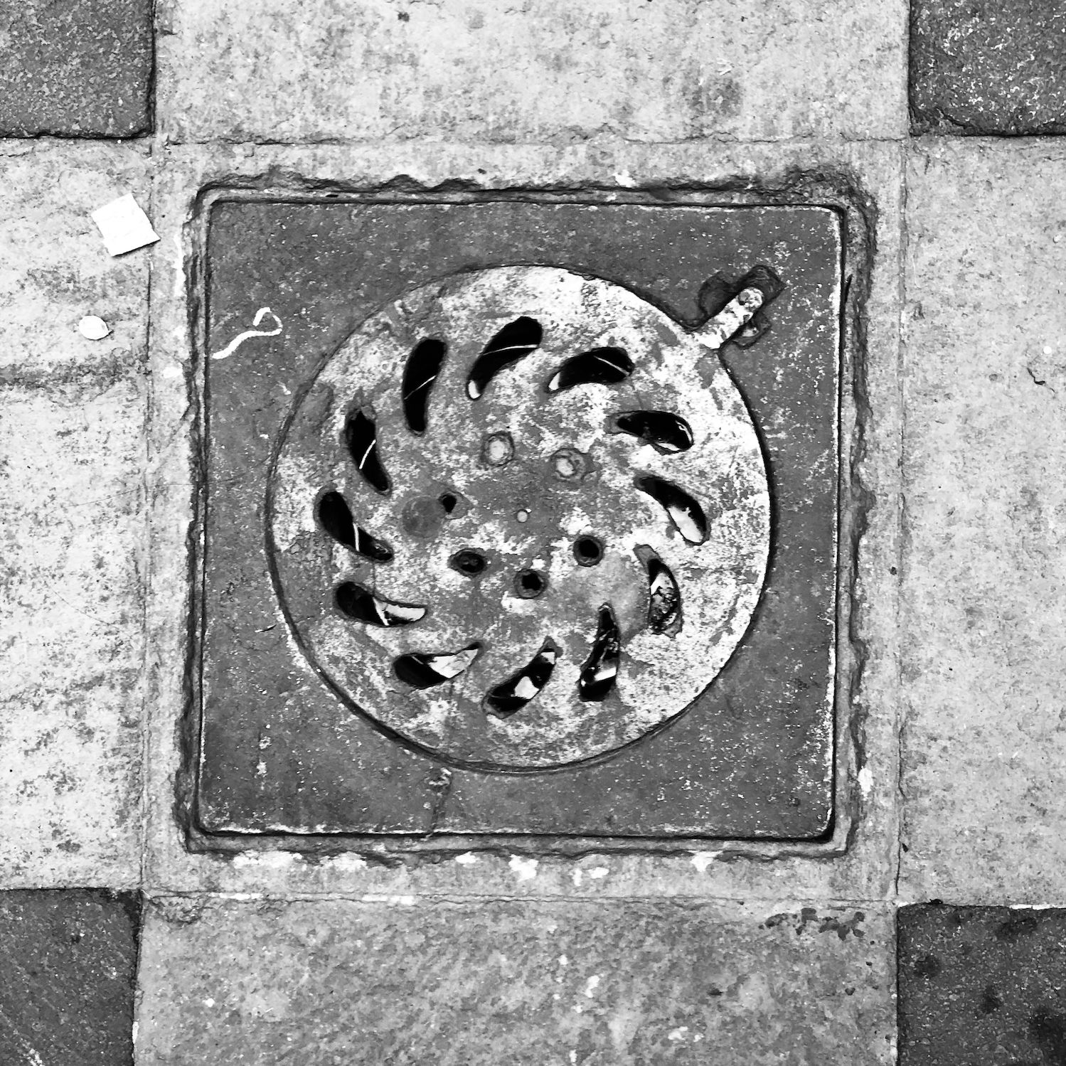 black and white image of a utility cover