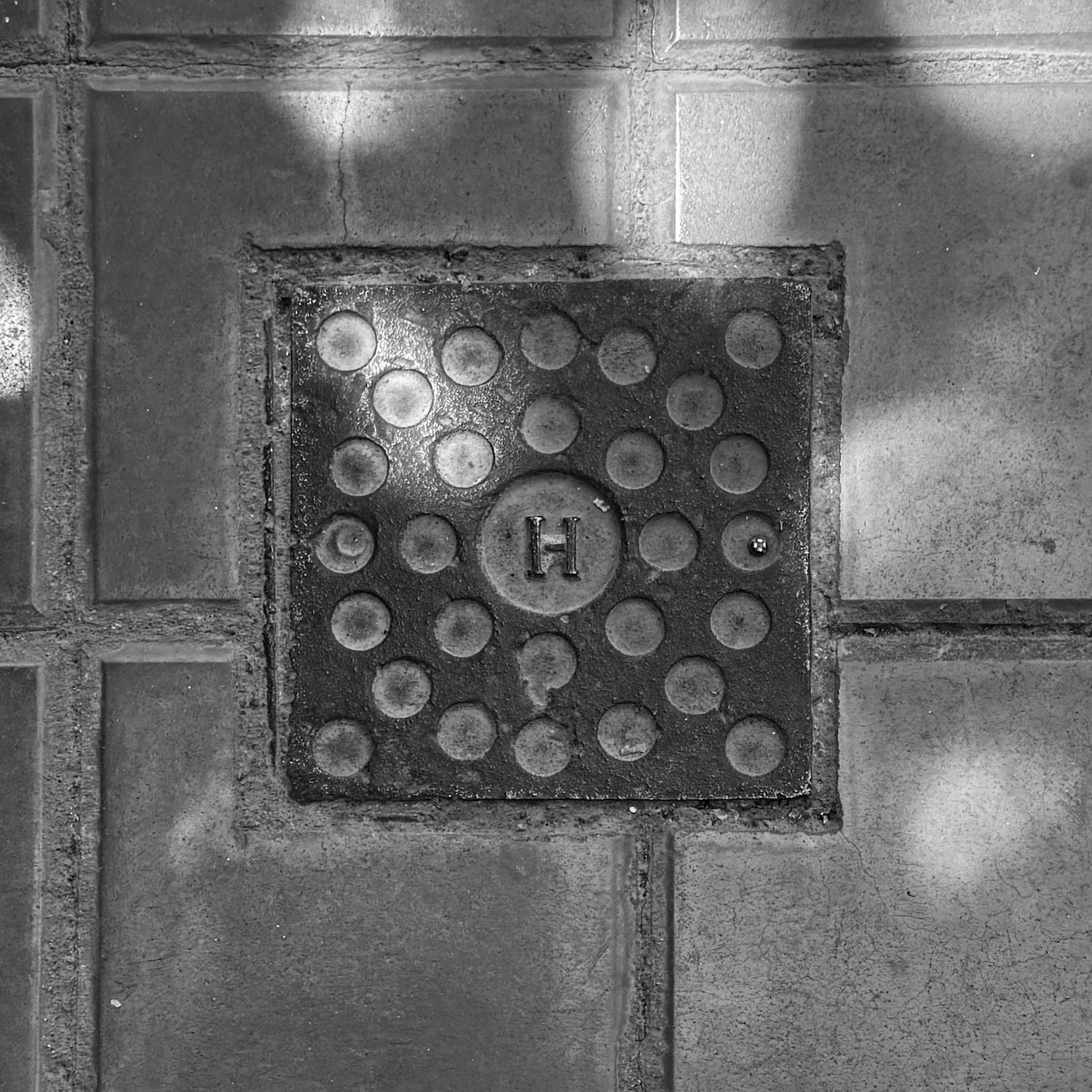 black and white image of a utility cover