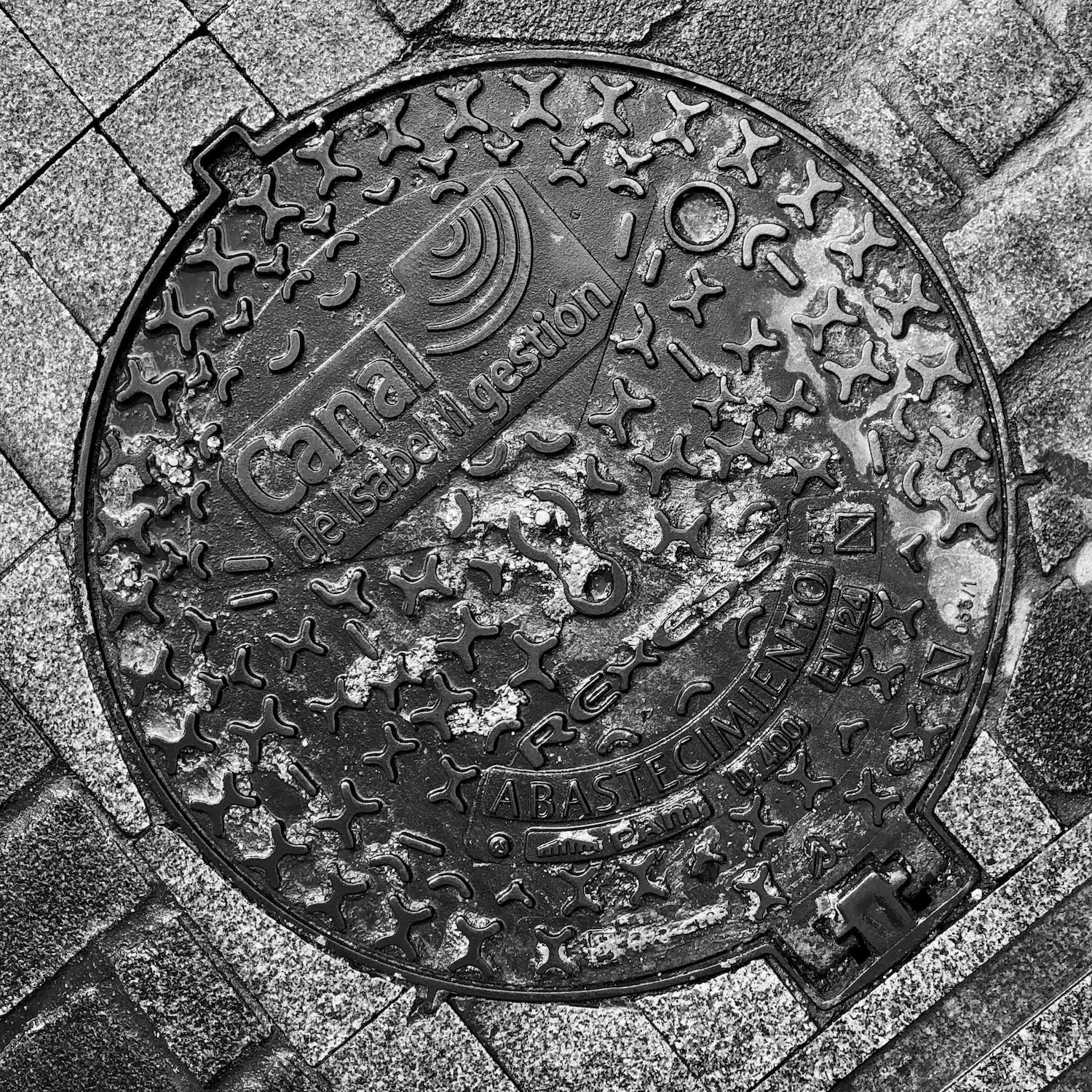 black and white image of a utility cover