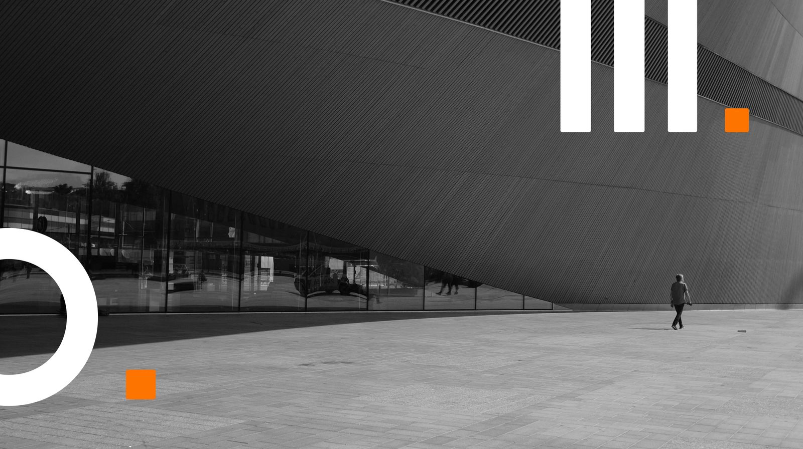 person walking in front of the Oodli Central library, Helsinki