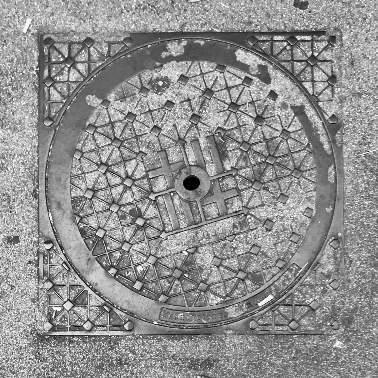 black and white image of a utility cover