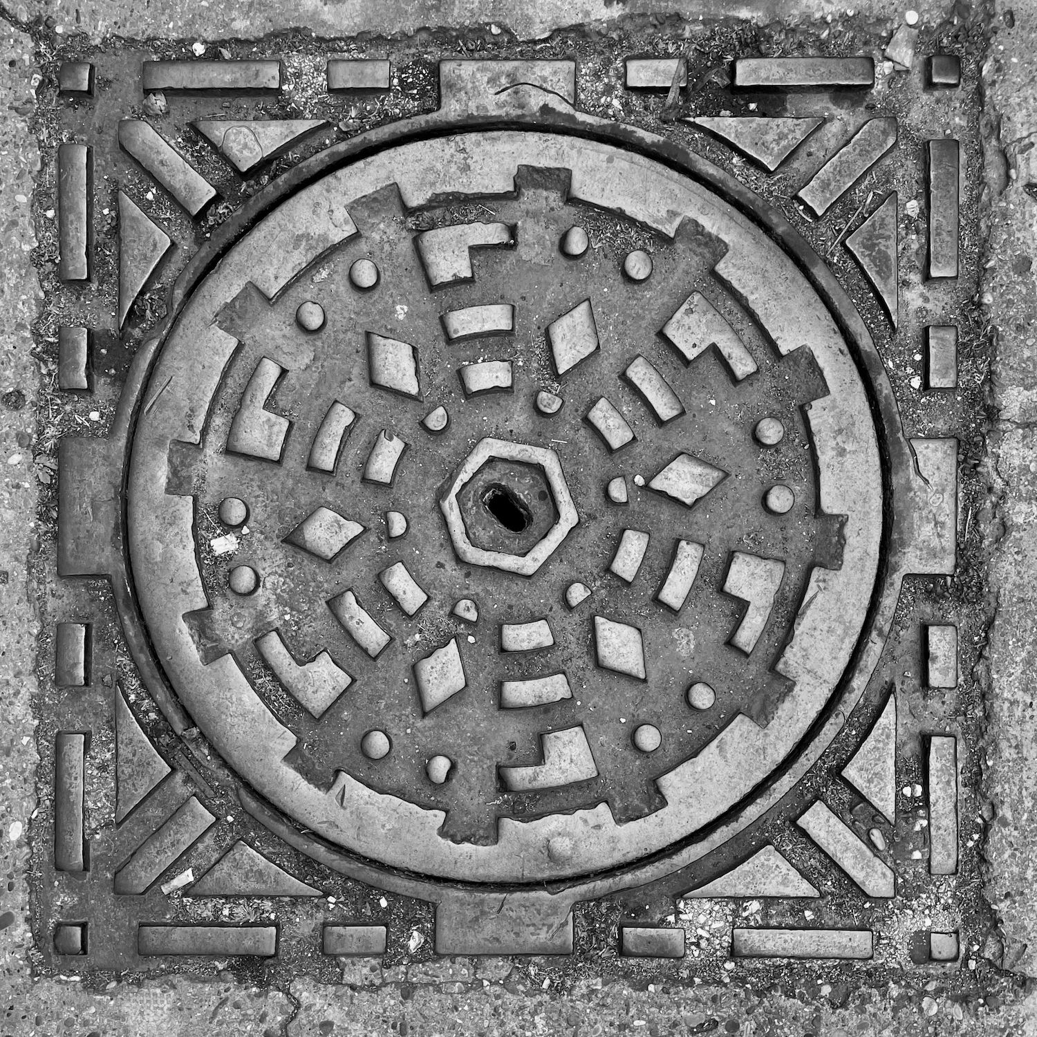 black and white image of a utility cover
