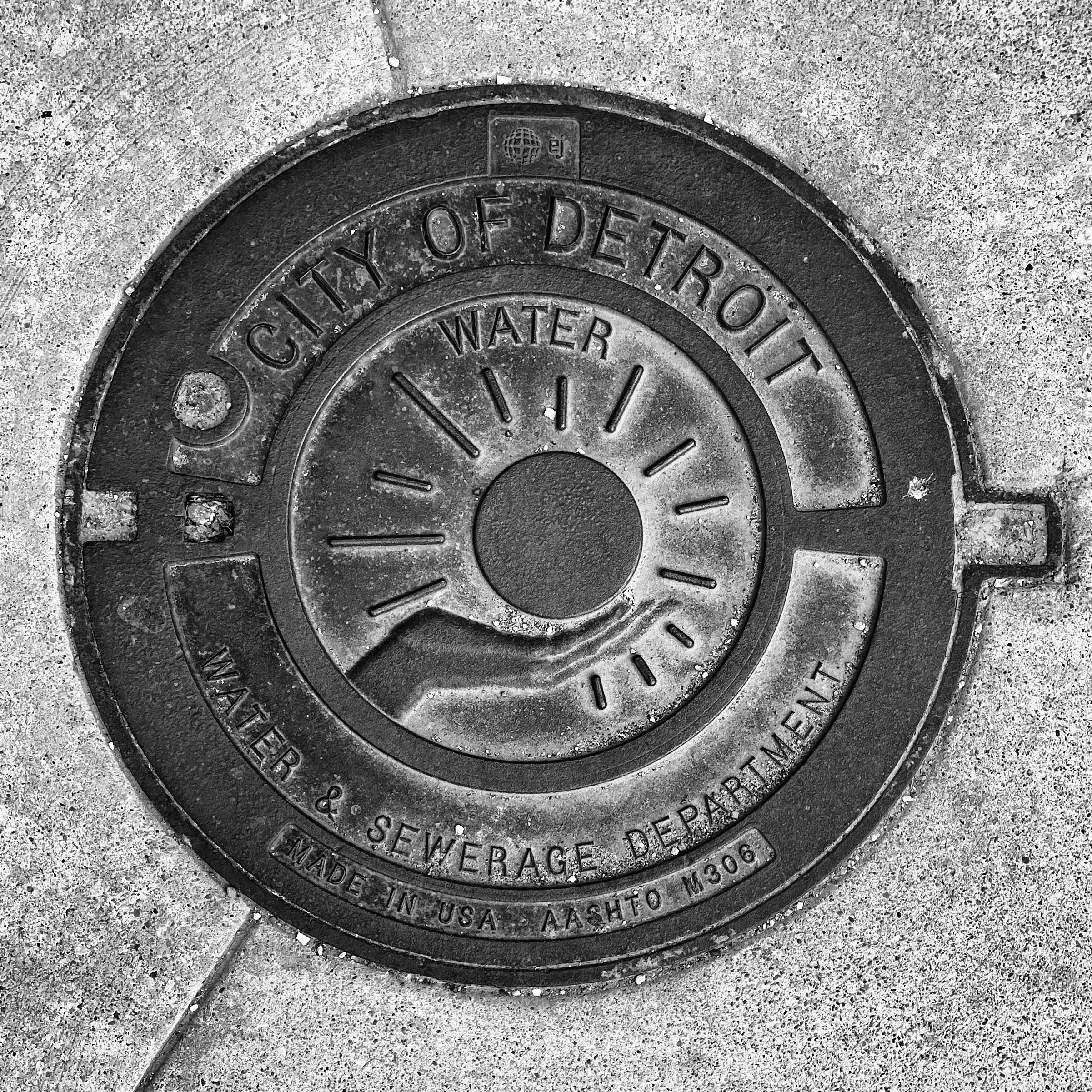 black and white image of a utility cover