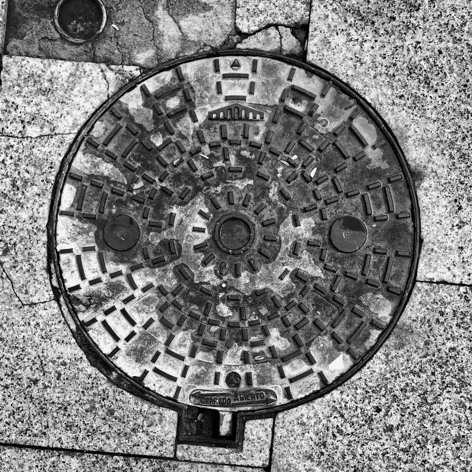 black and white image of a utility cover