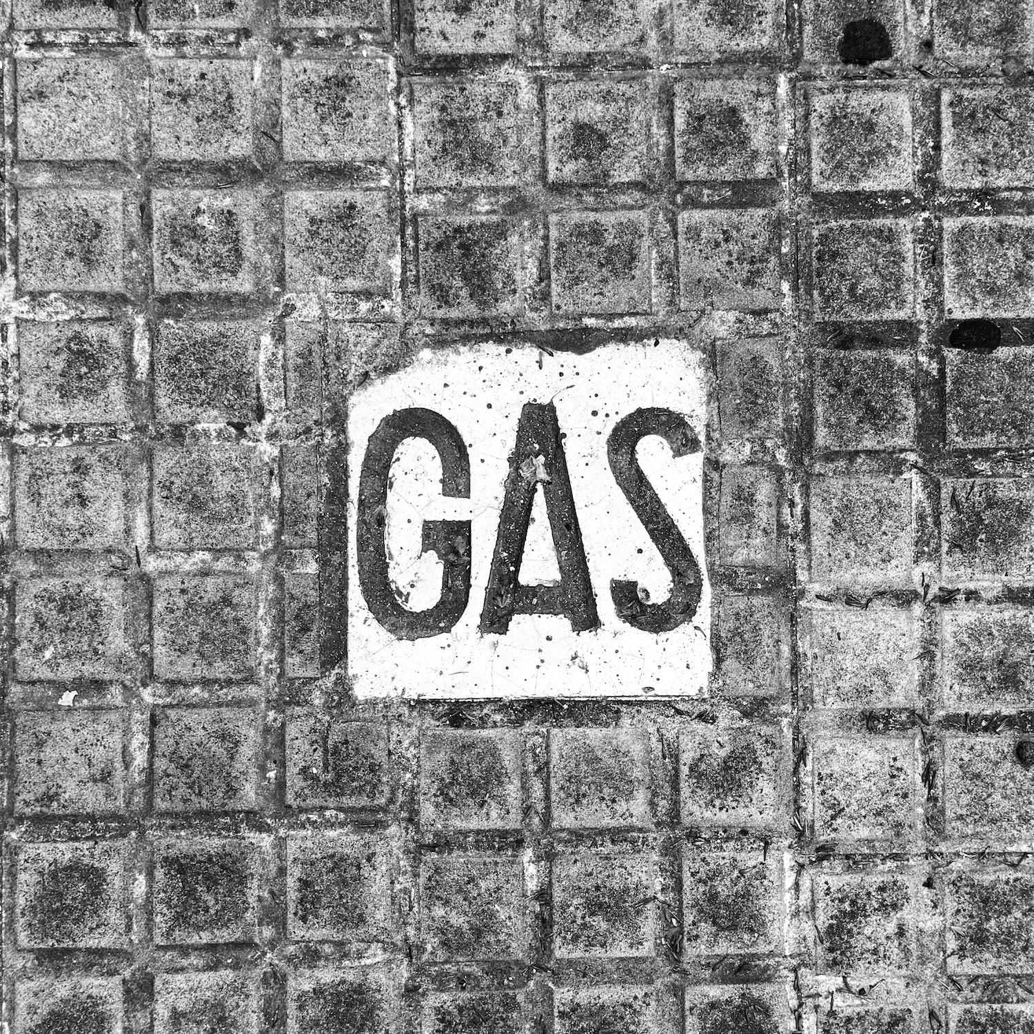 black and white image of a utility cover