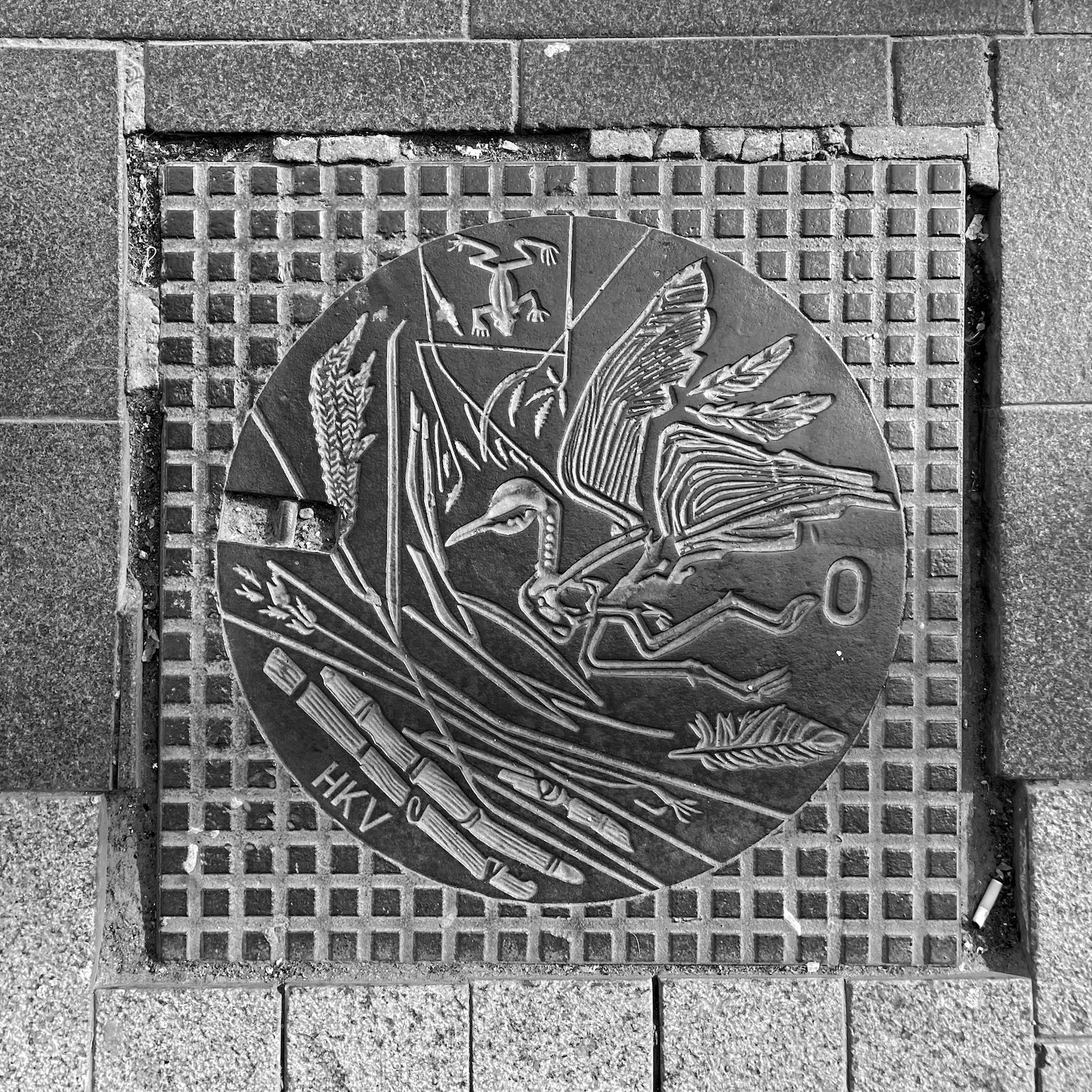 black and white image of a utility cover