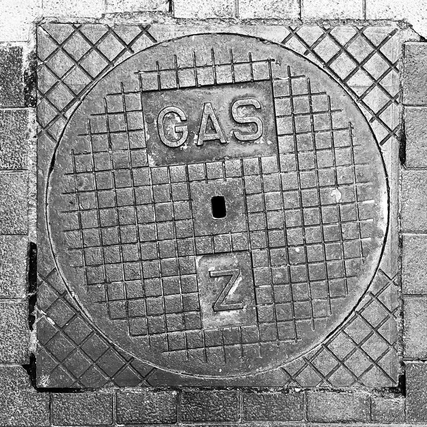 black and white image of a utility cover