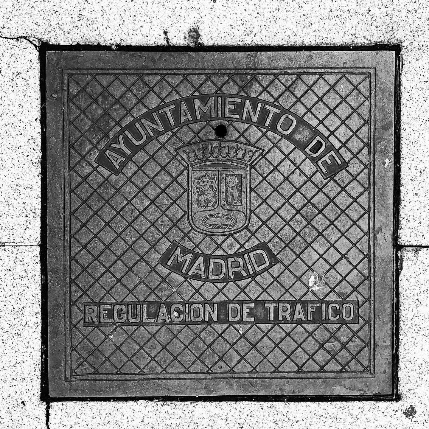 black and white image of a utility cover