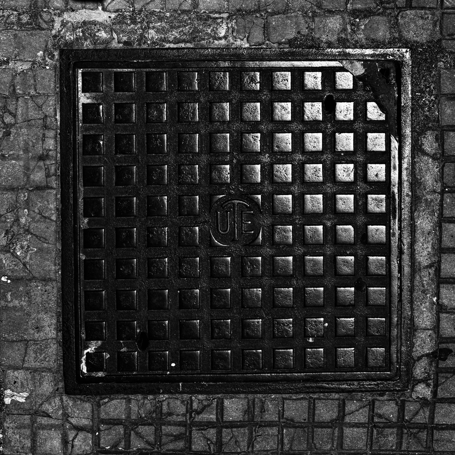 black and white image of a utility cover