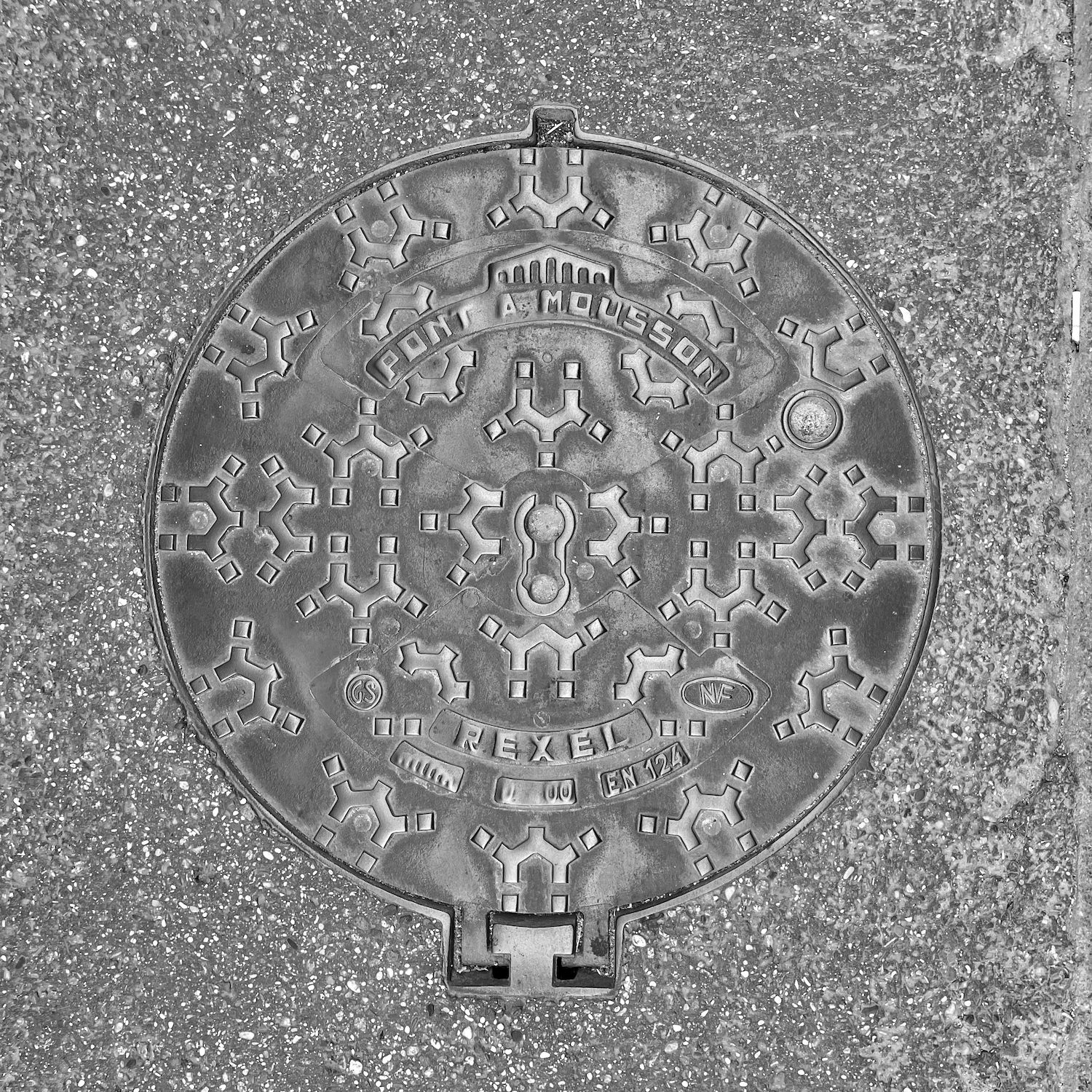 black and white image of a utility cover