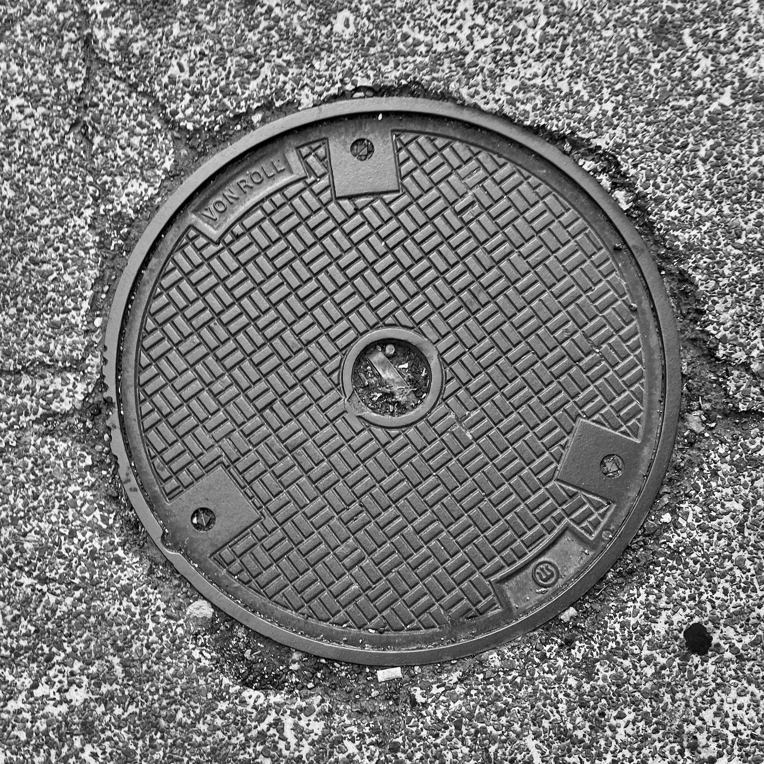 black and white image of a utility cover