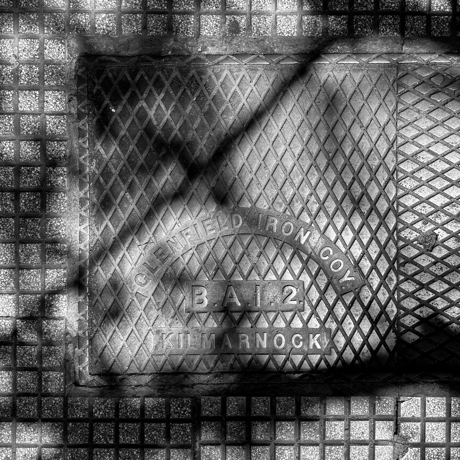 black and white image of a utility cover
