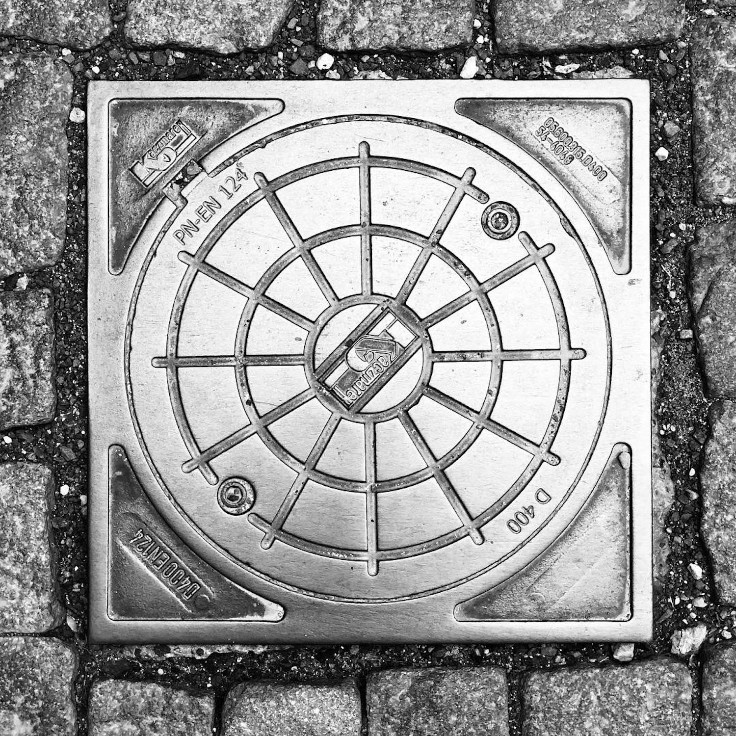 black and white image of a utility cover