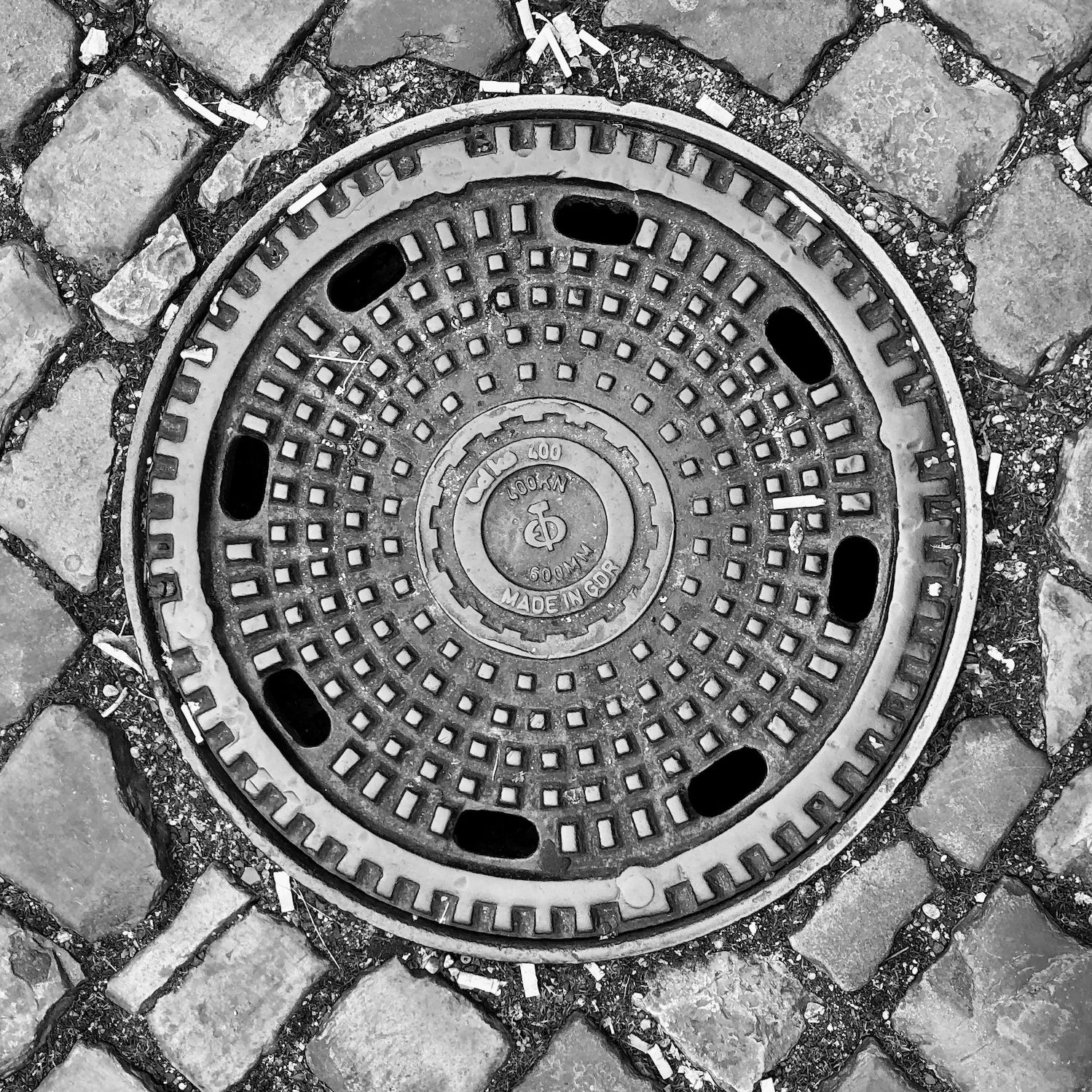 black and white image of a utility cover