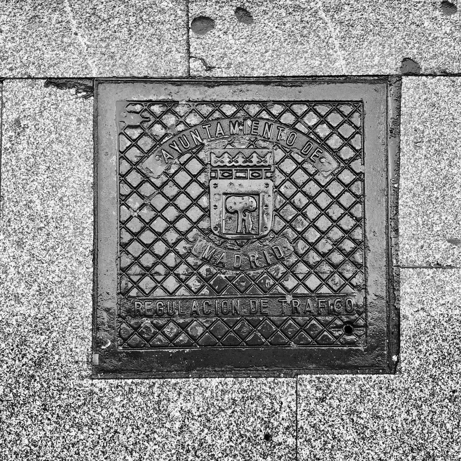 black and white image of a utility cover