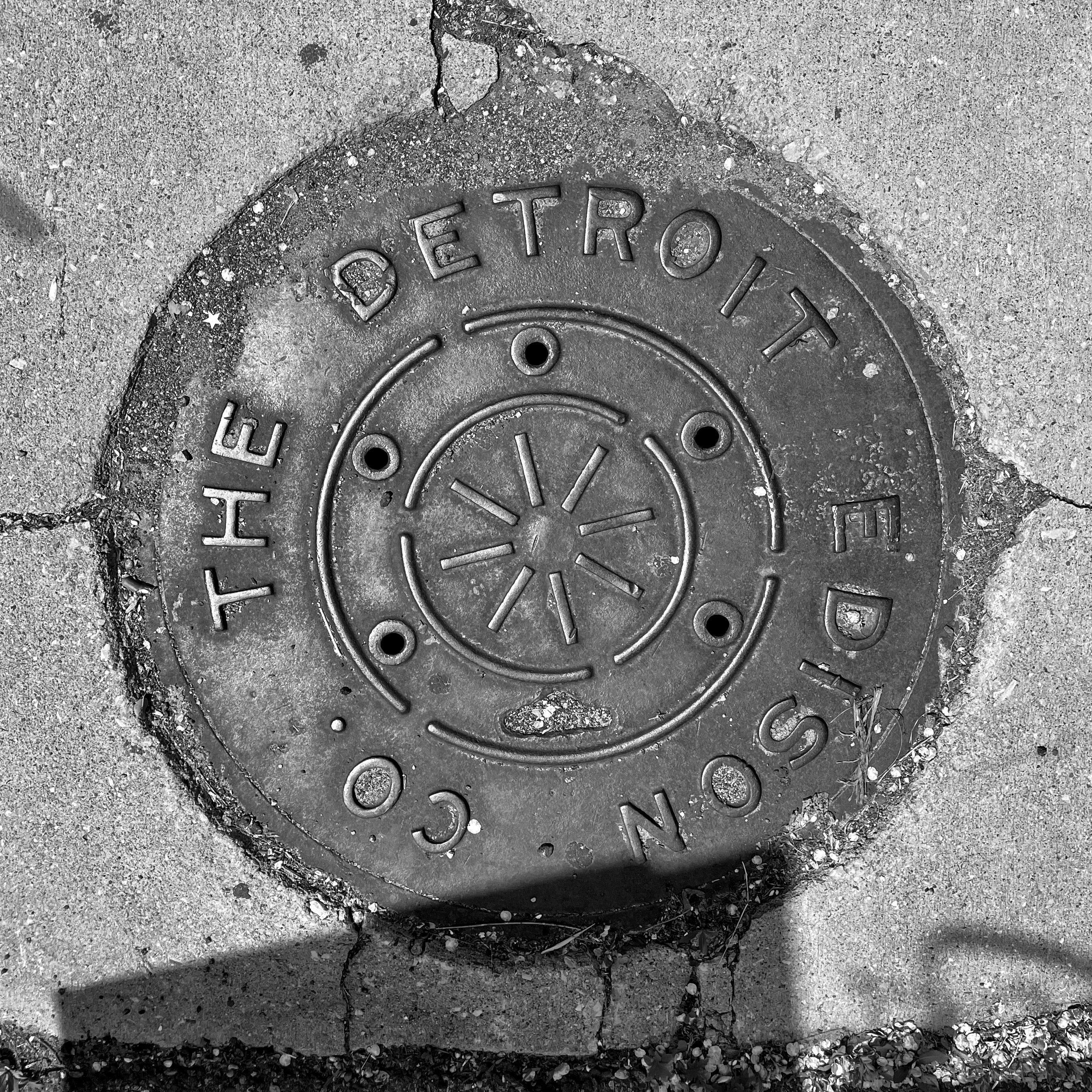 black and white image of a utility cover