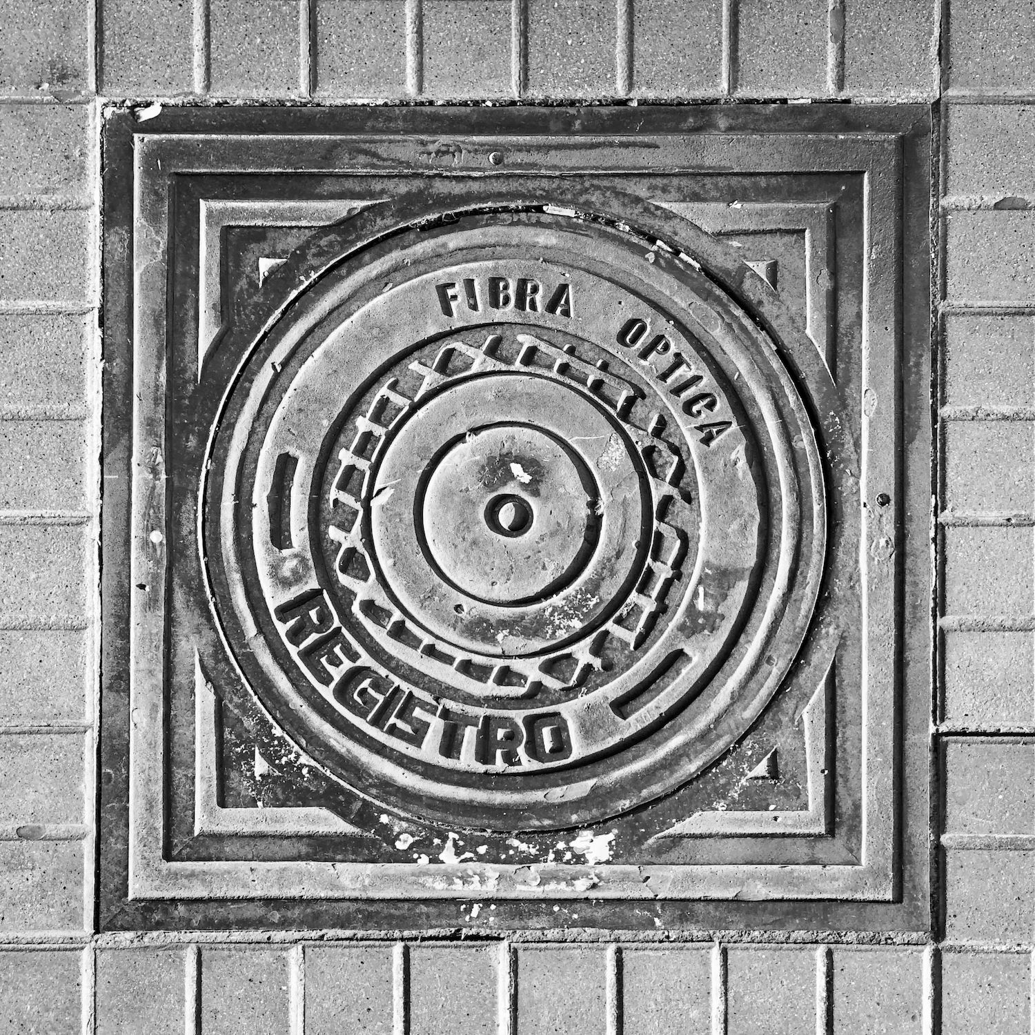 black and white image of a utility cover
