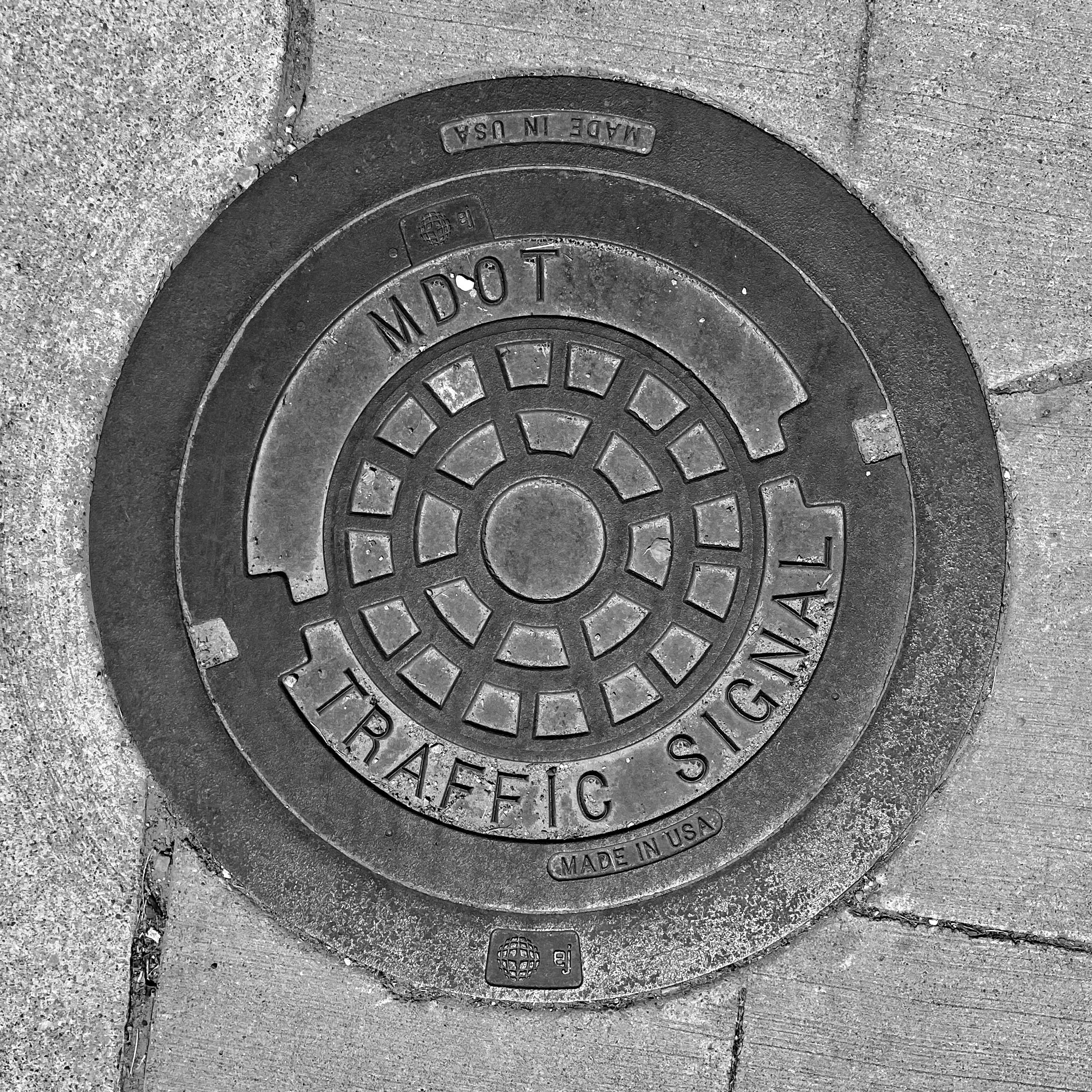 black and white image of a utility cover