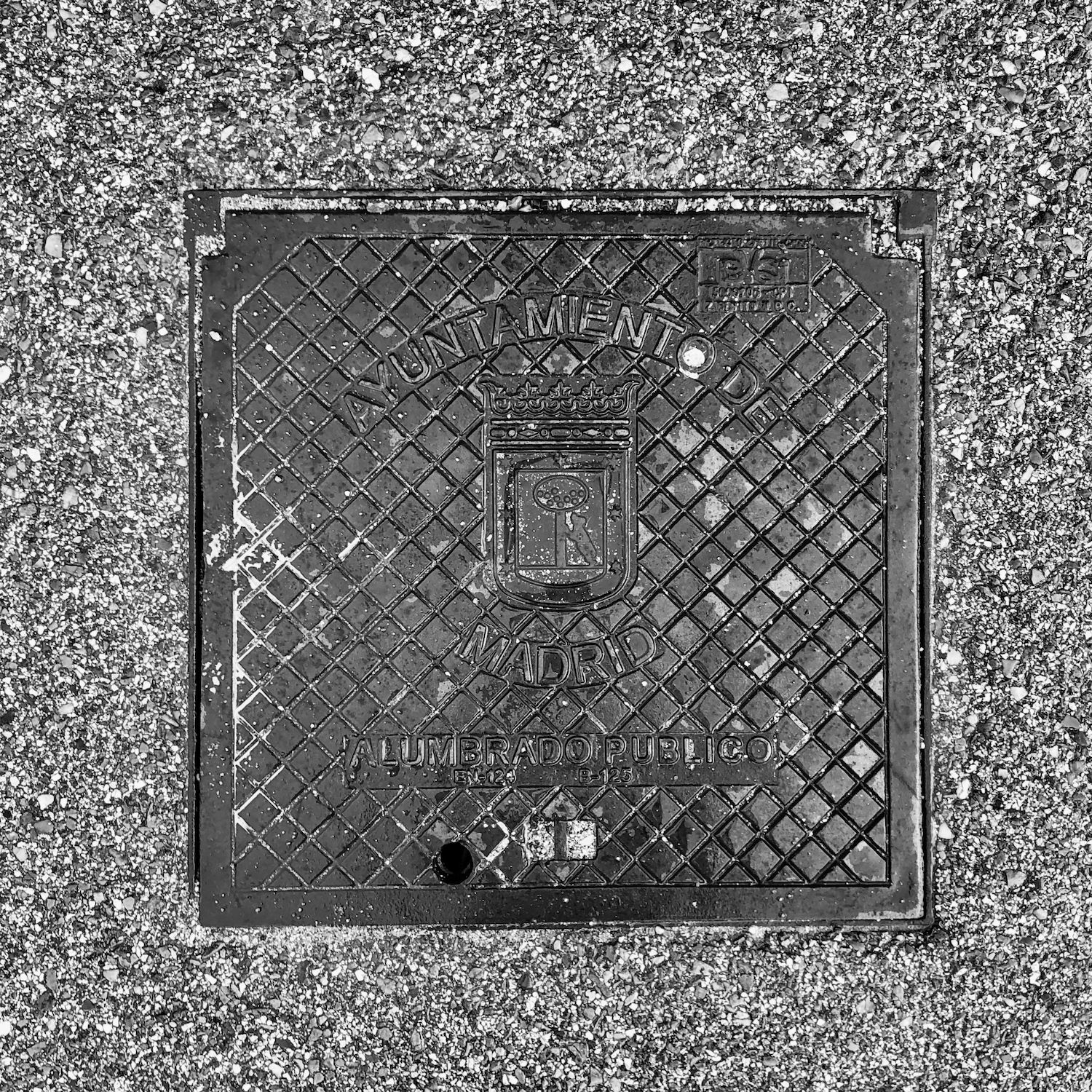 black and white image of a utility cover