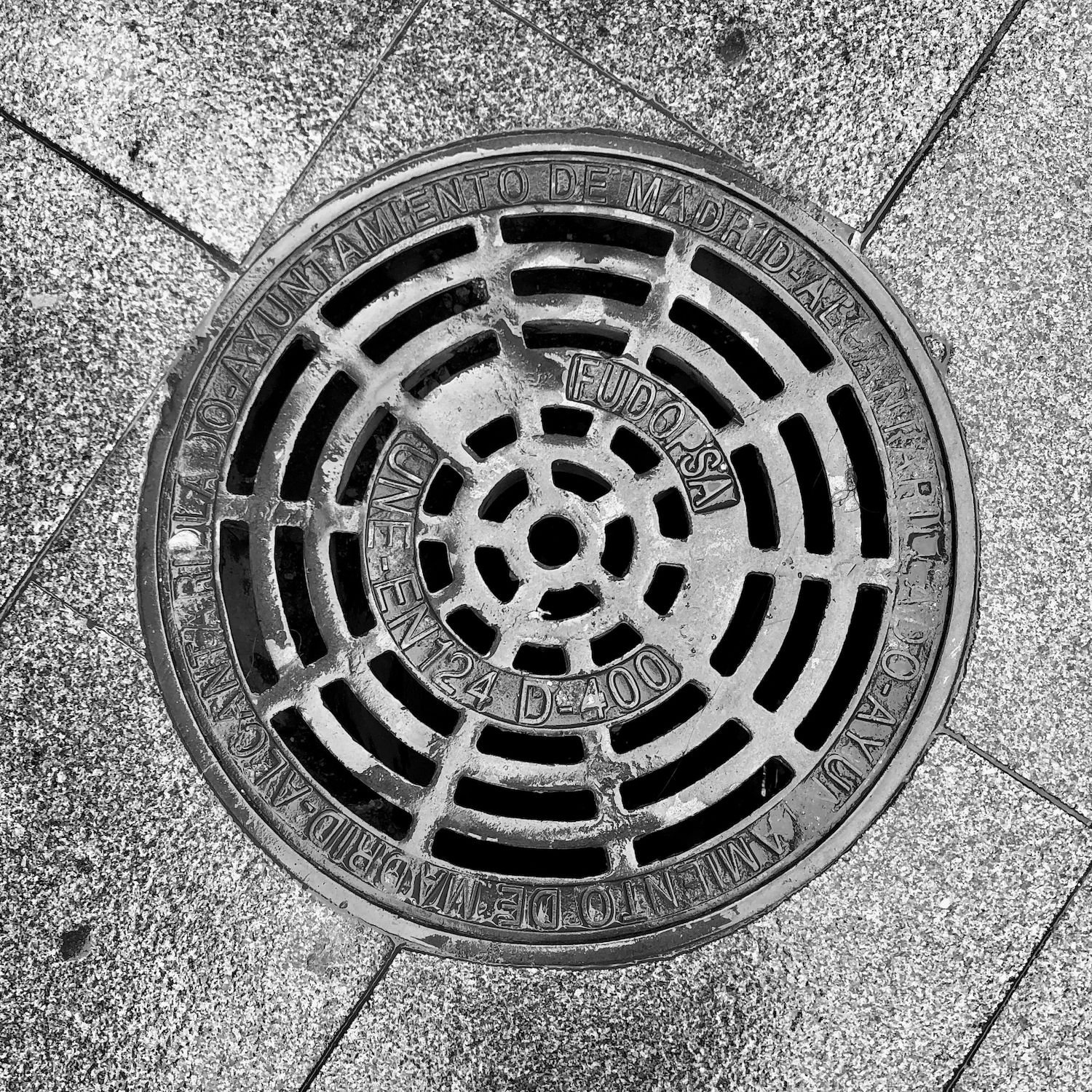 black and white image of a utility cover