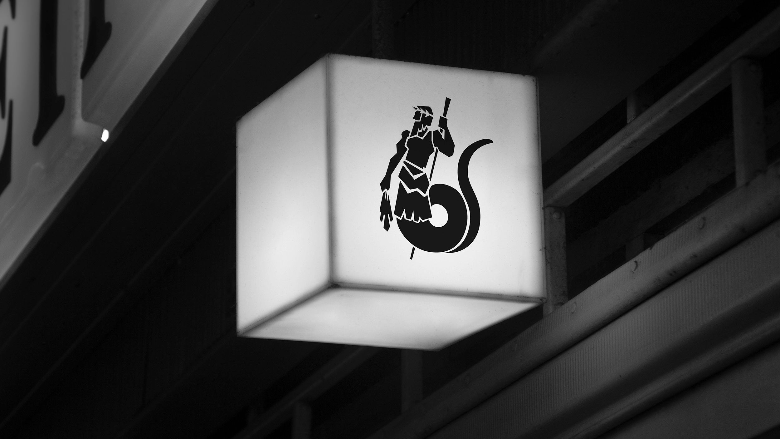 black and white image of a small square street lamp with logo on side