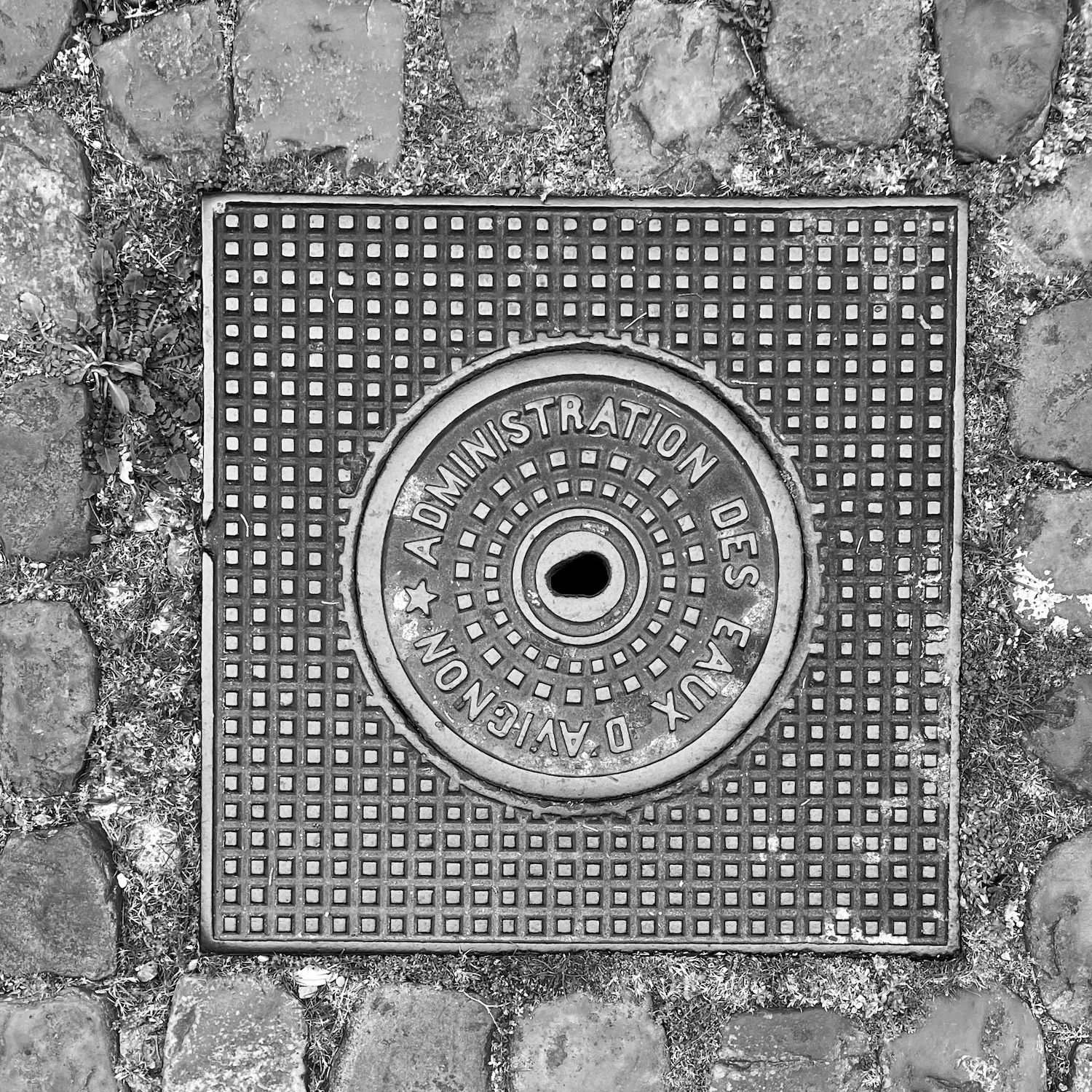 black and white image of a utility cover