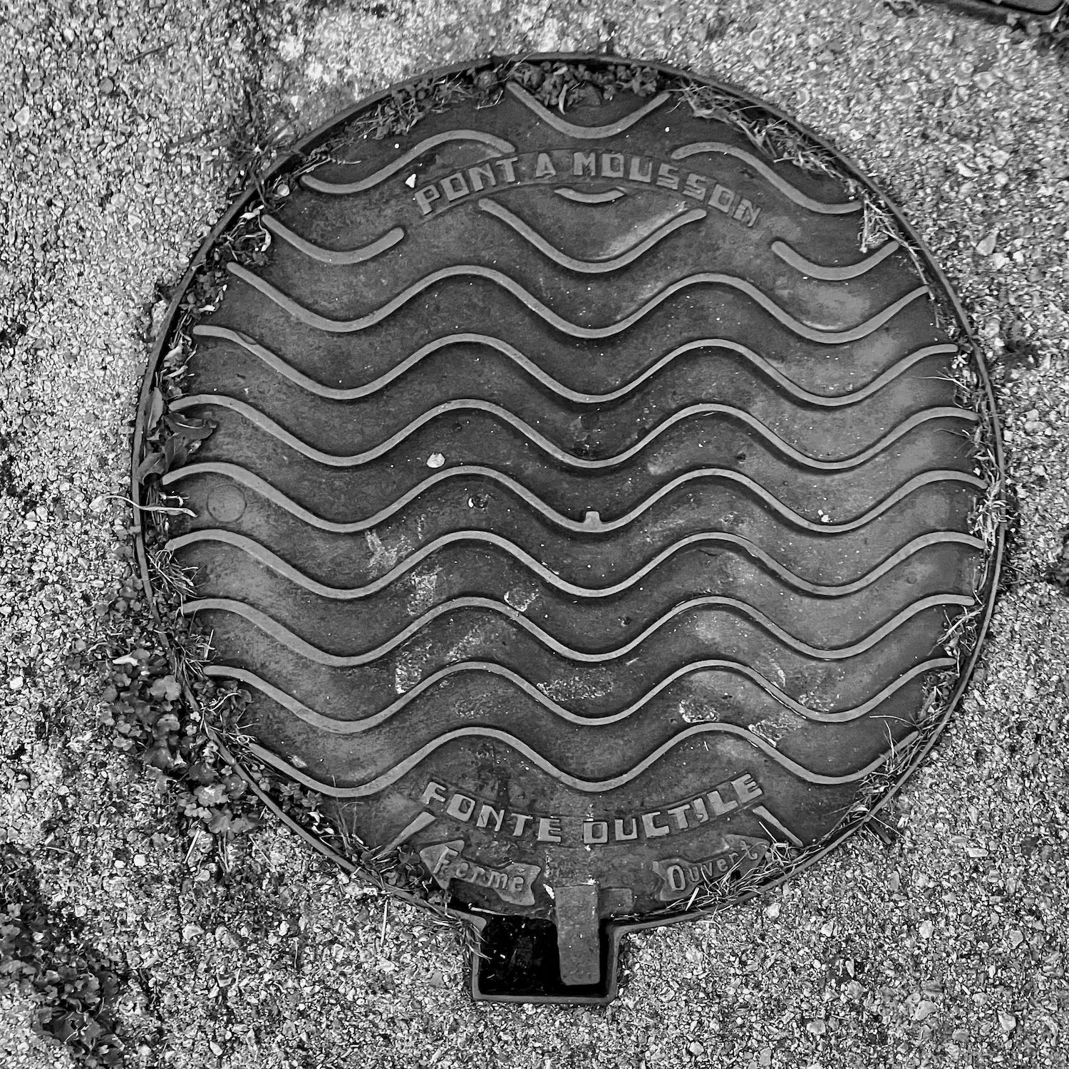black and white image of a utility cover