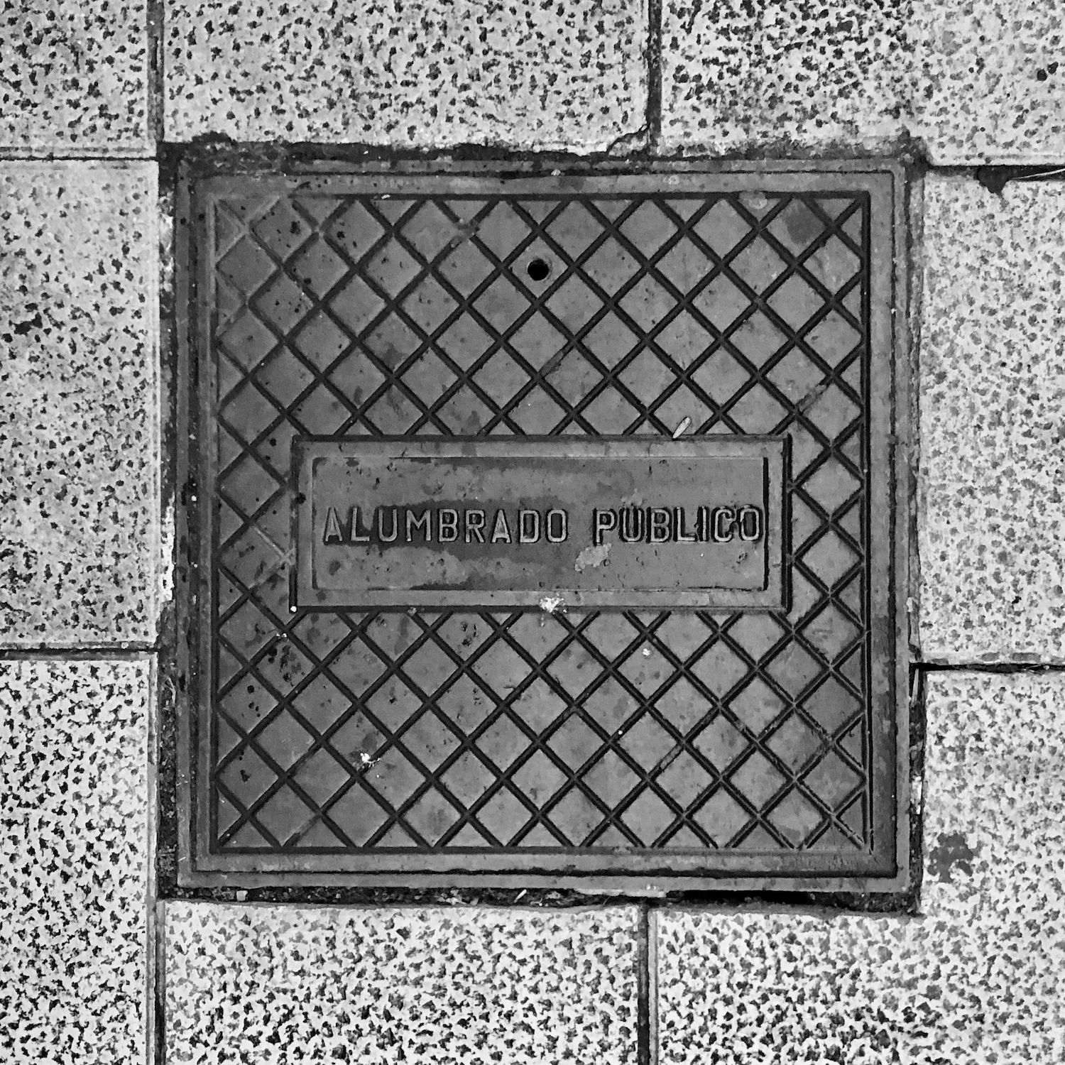 black and white image of a utility cover