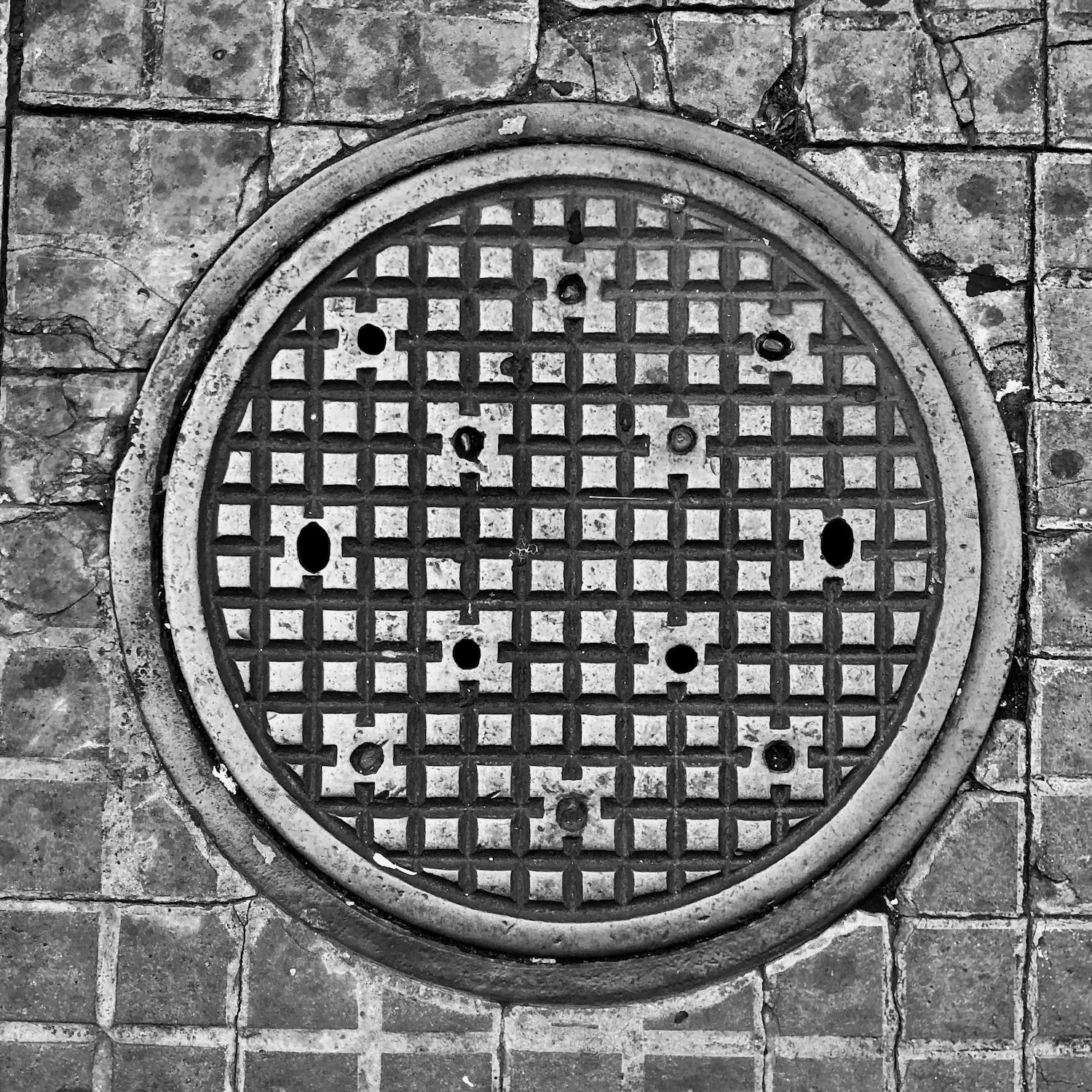 black and white image of a utility cover
