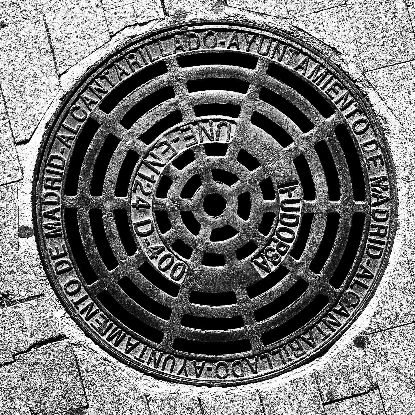 black and white image of a utility cover