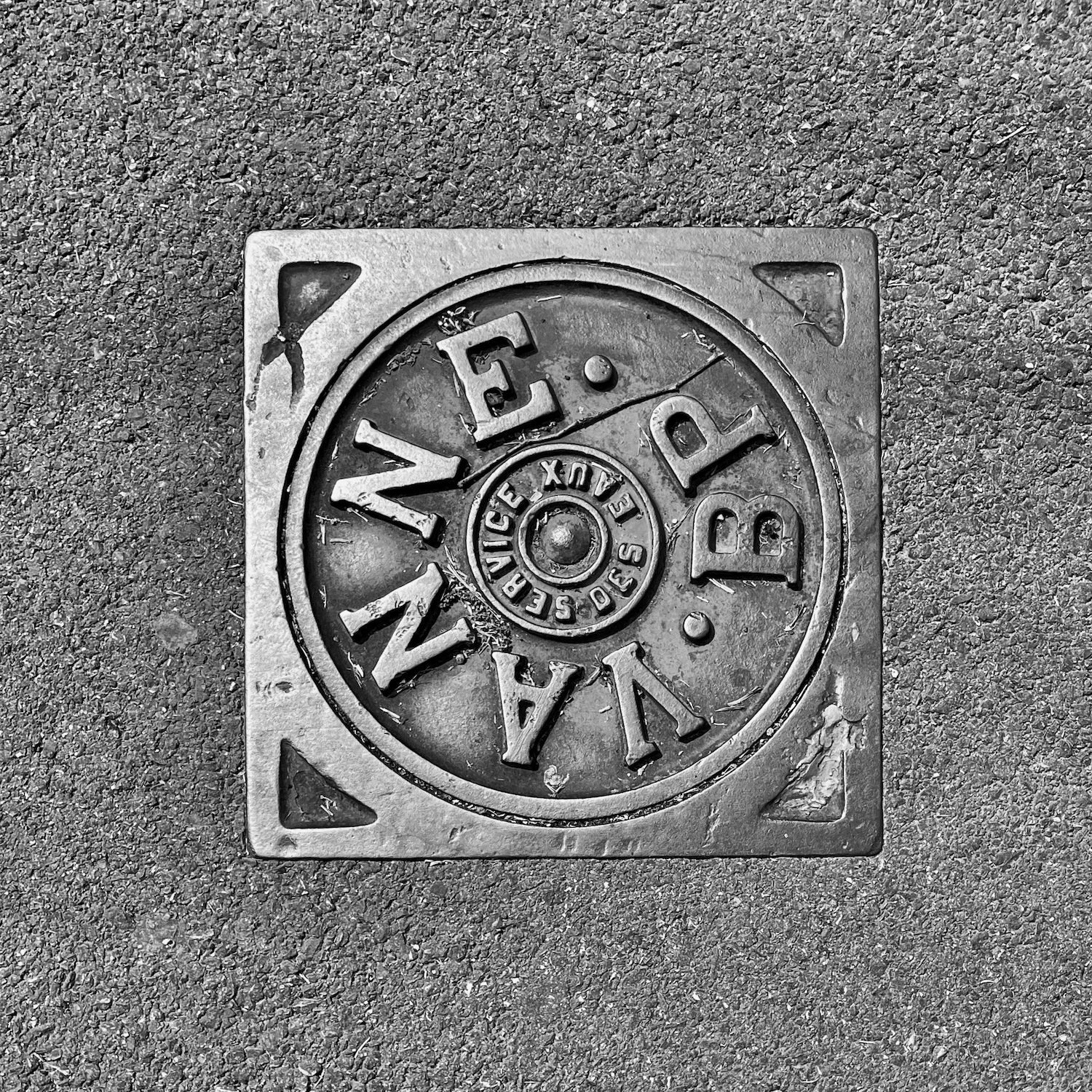 black and white image of a utility cover
