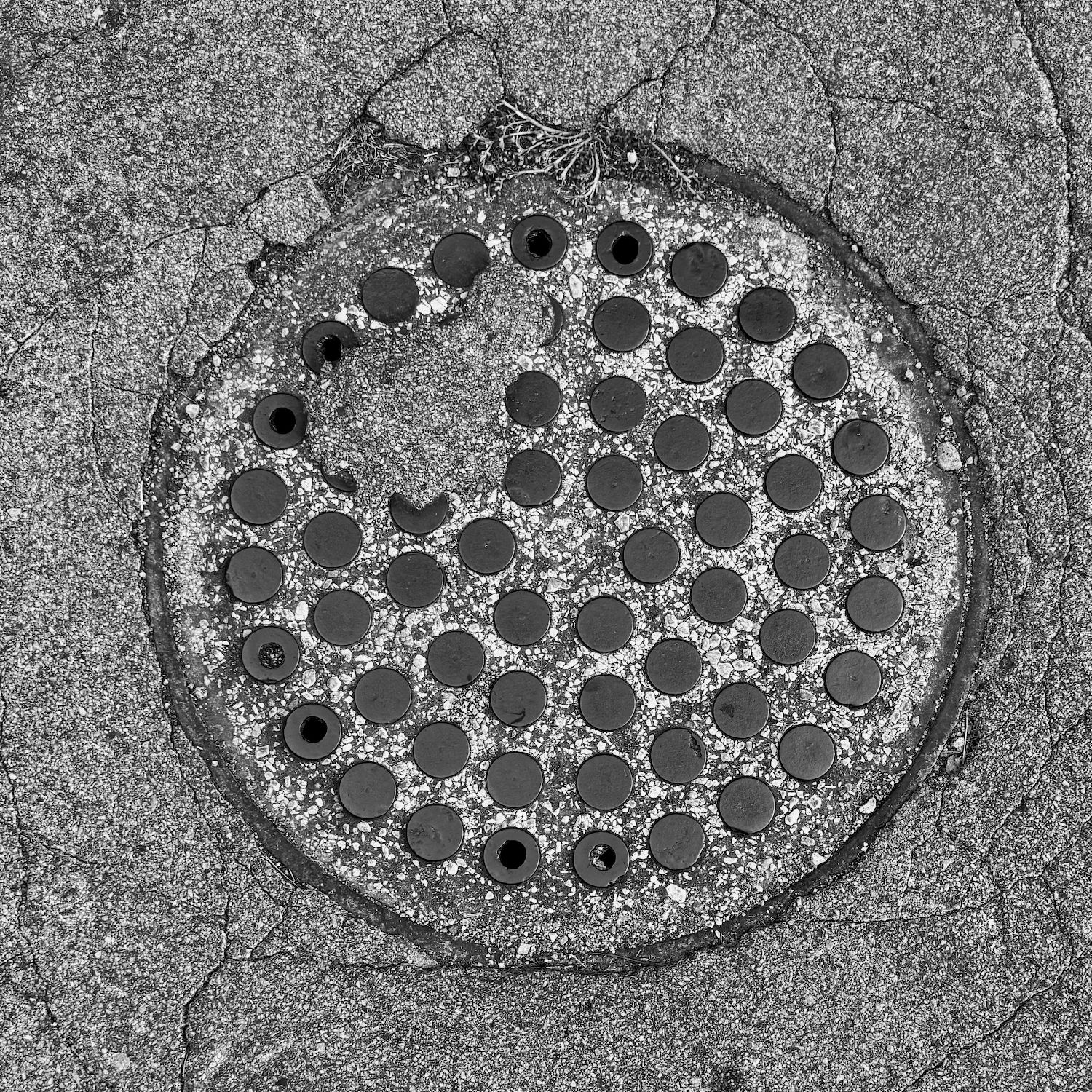 black and white image of a utility cover