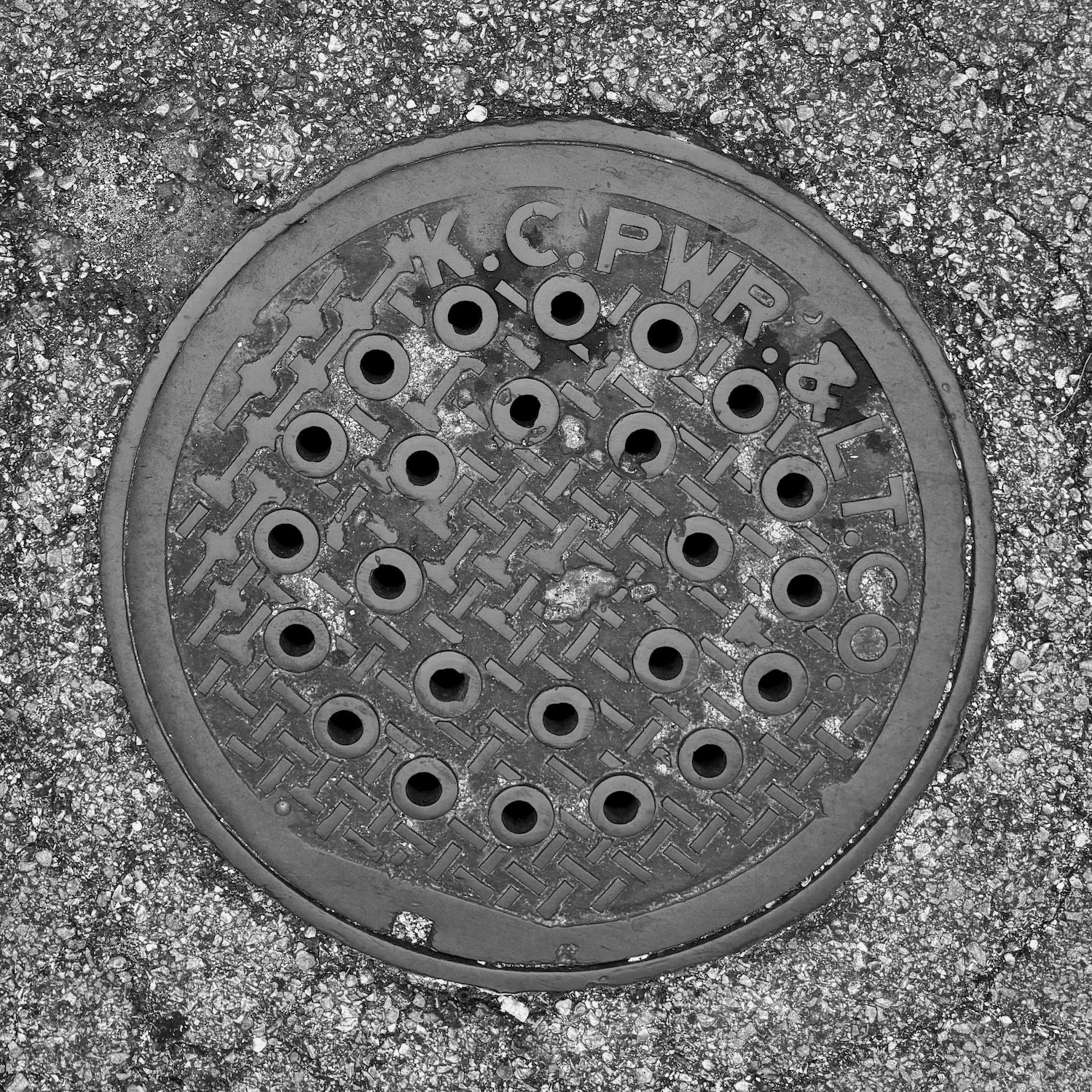 black and white image of a utility cover