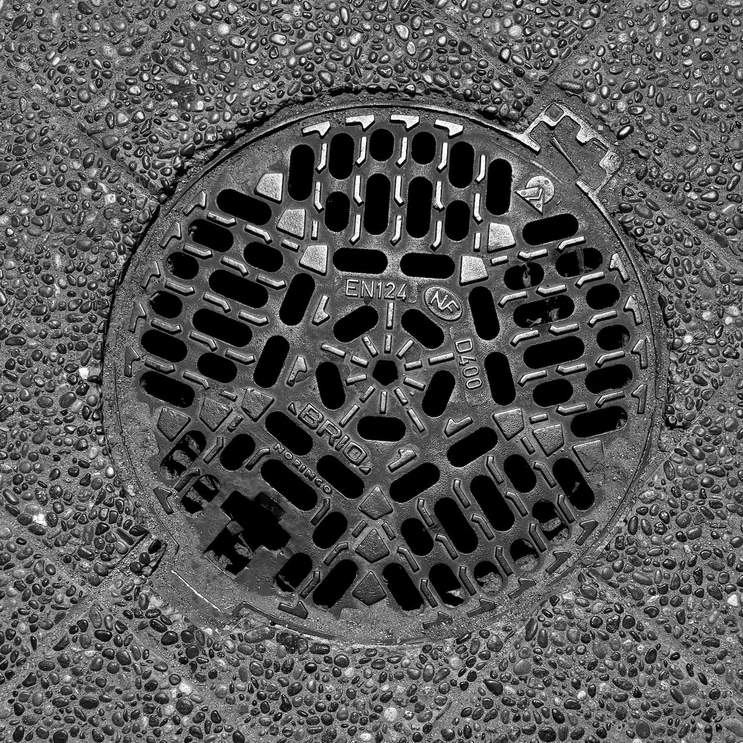 black and white image of a utility cover