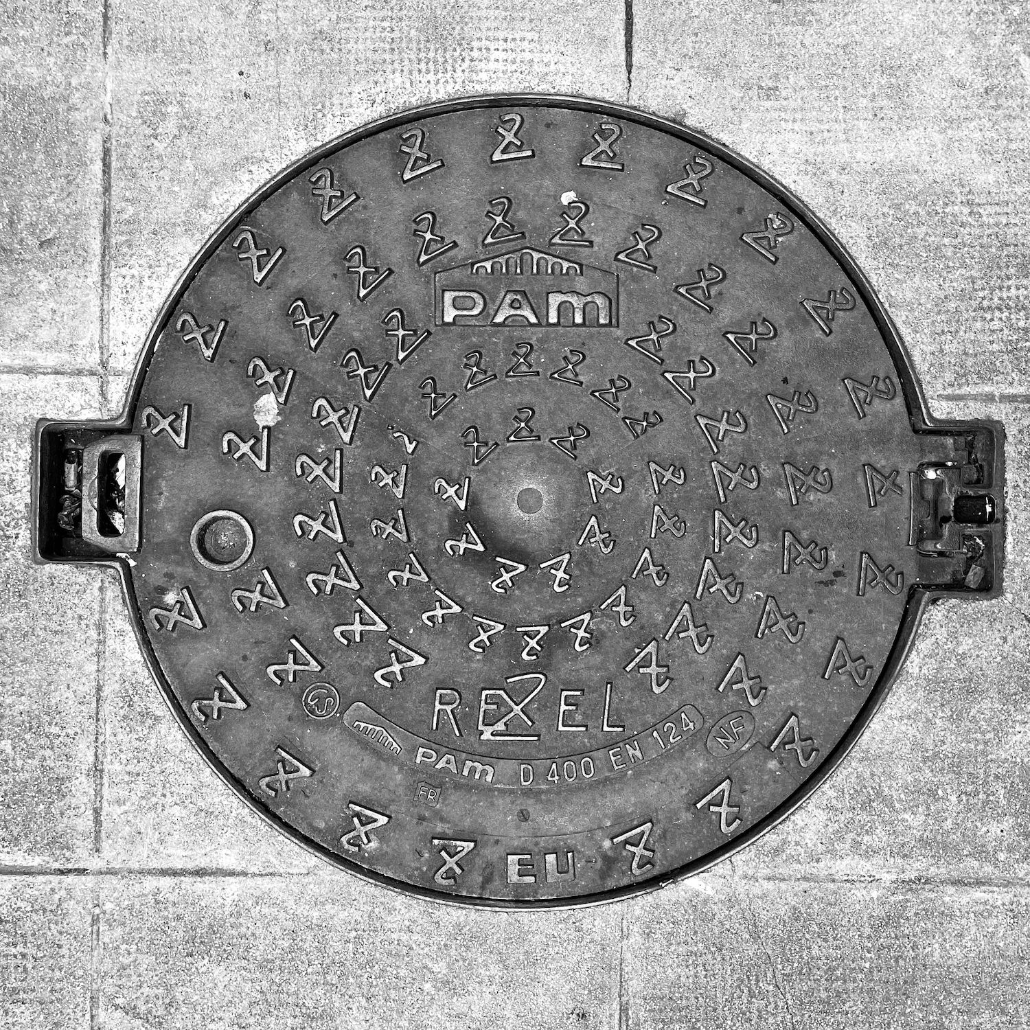 black and white image of a utility cover