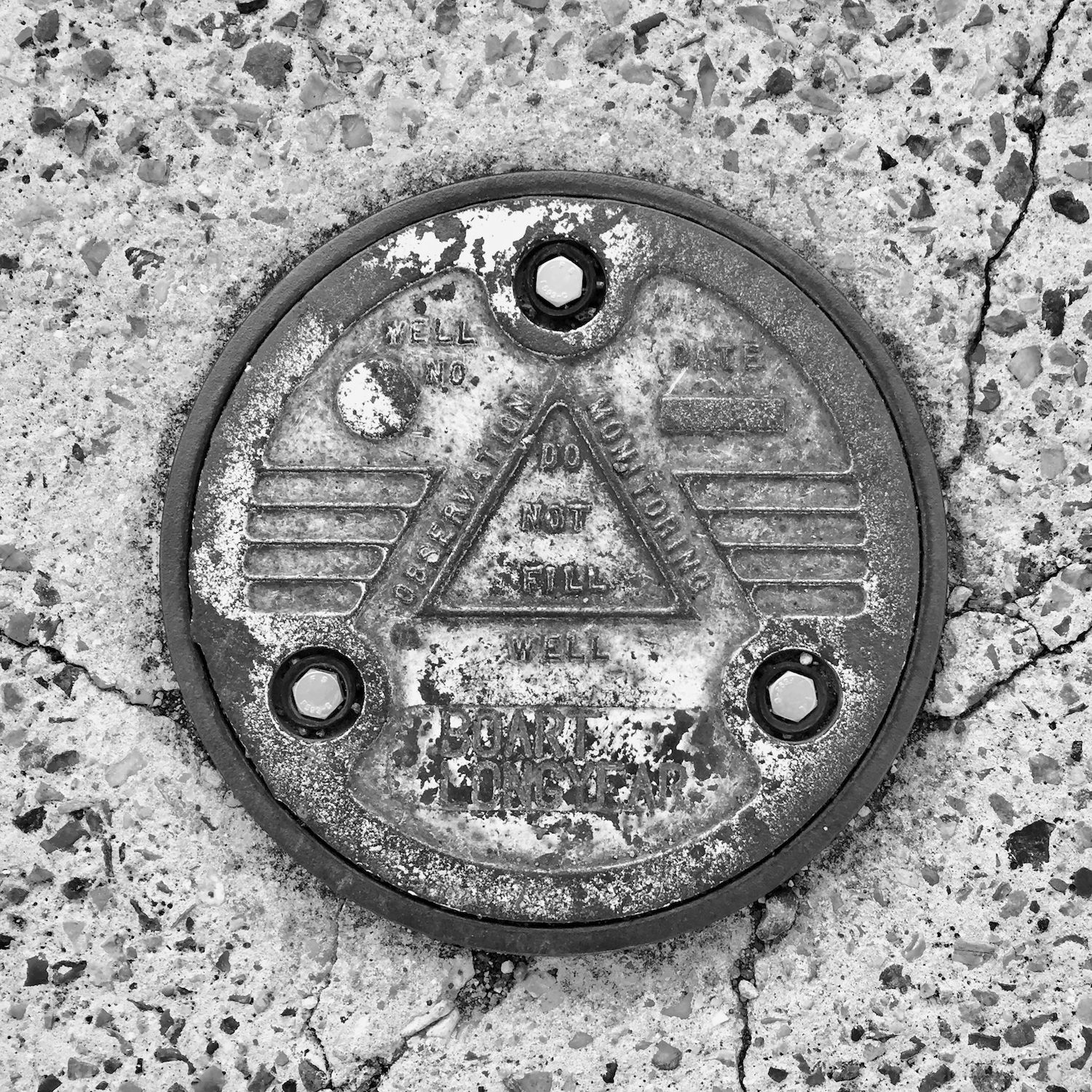 black and white image of a utility cover