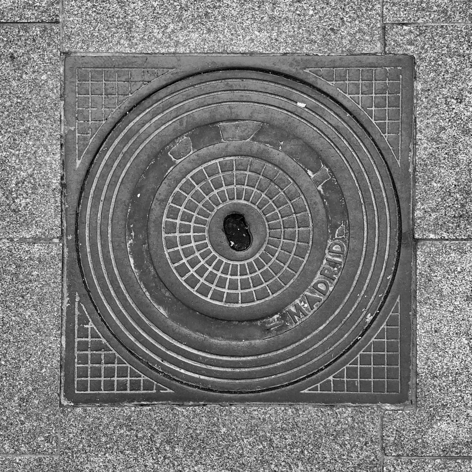 black and white image of a utility cover