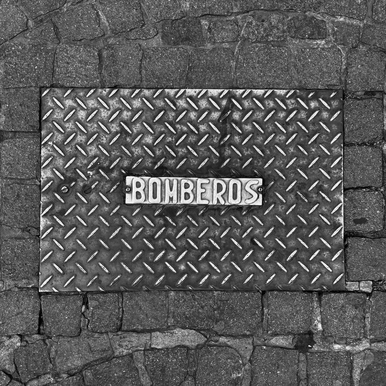 black and white image of a utility cover