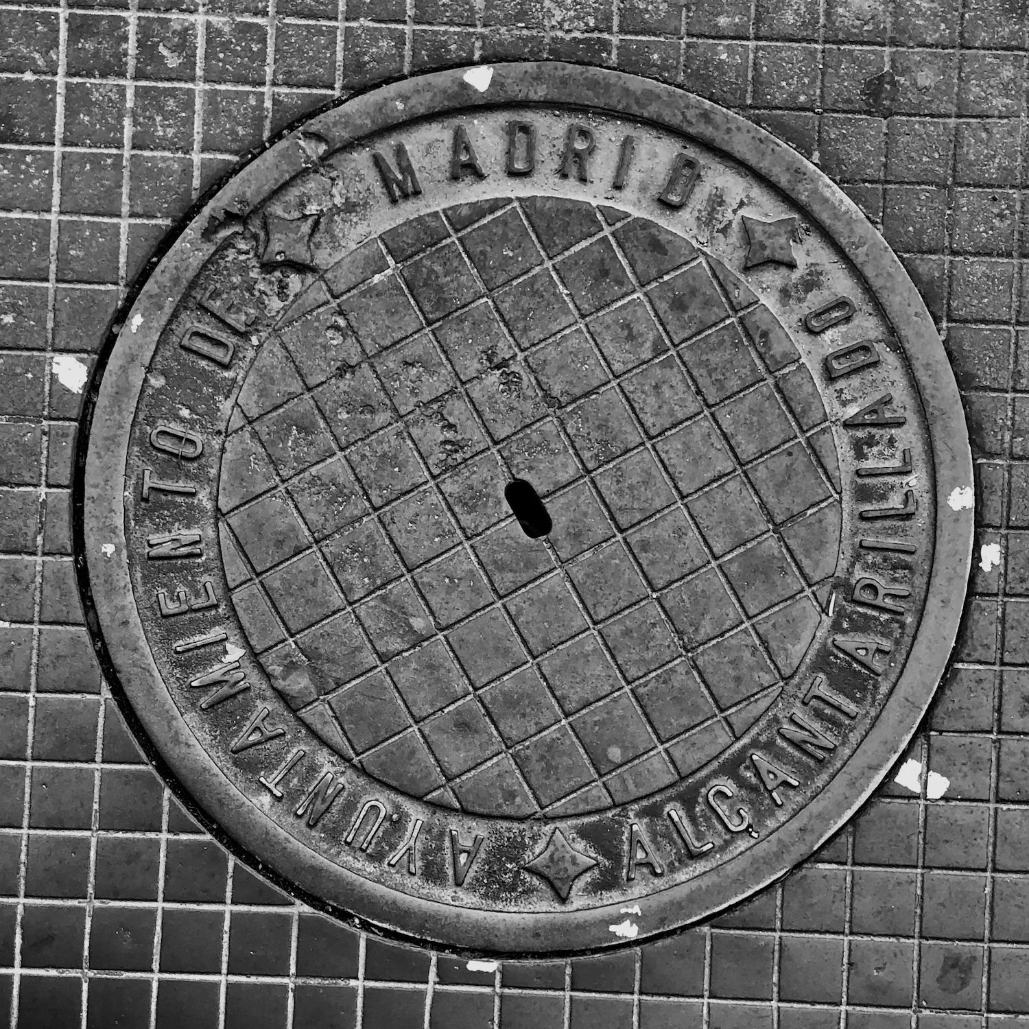 black and white image of a utility cover