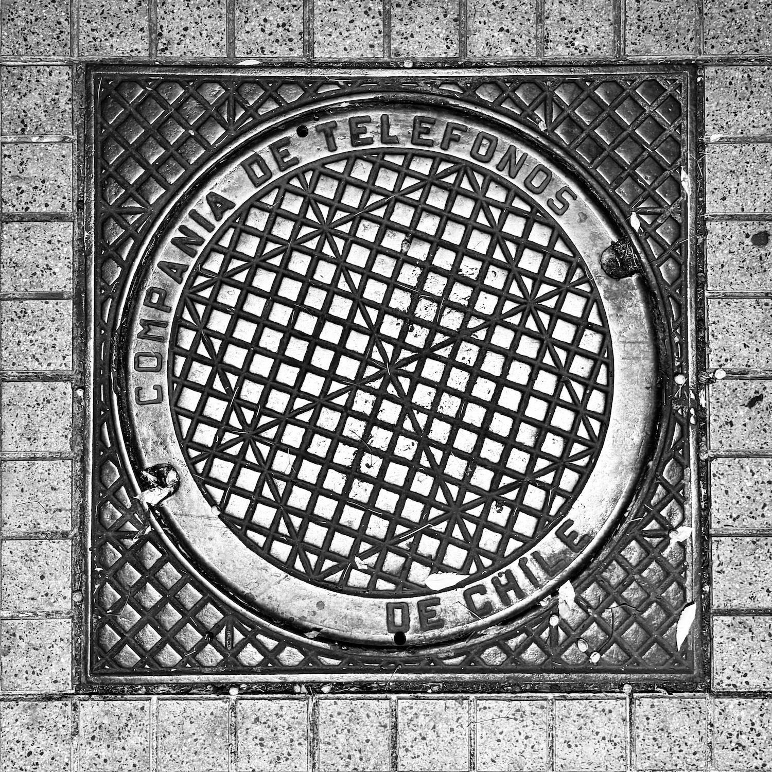 black and white image of a utility cover
