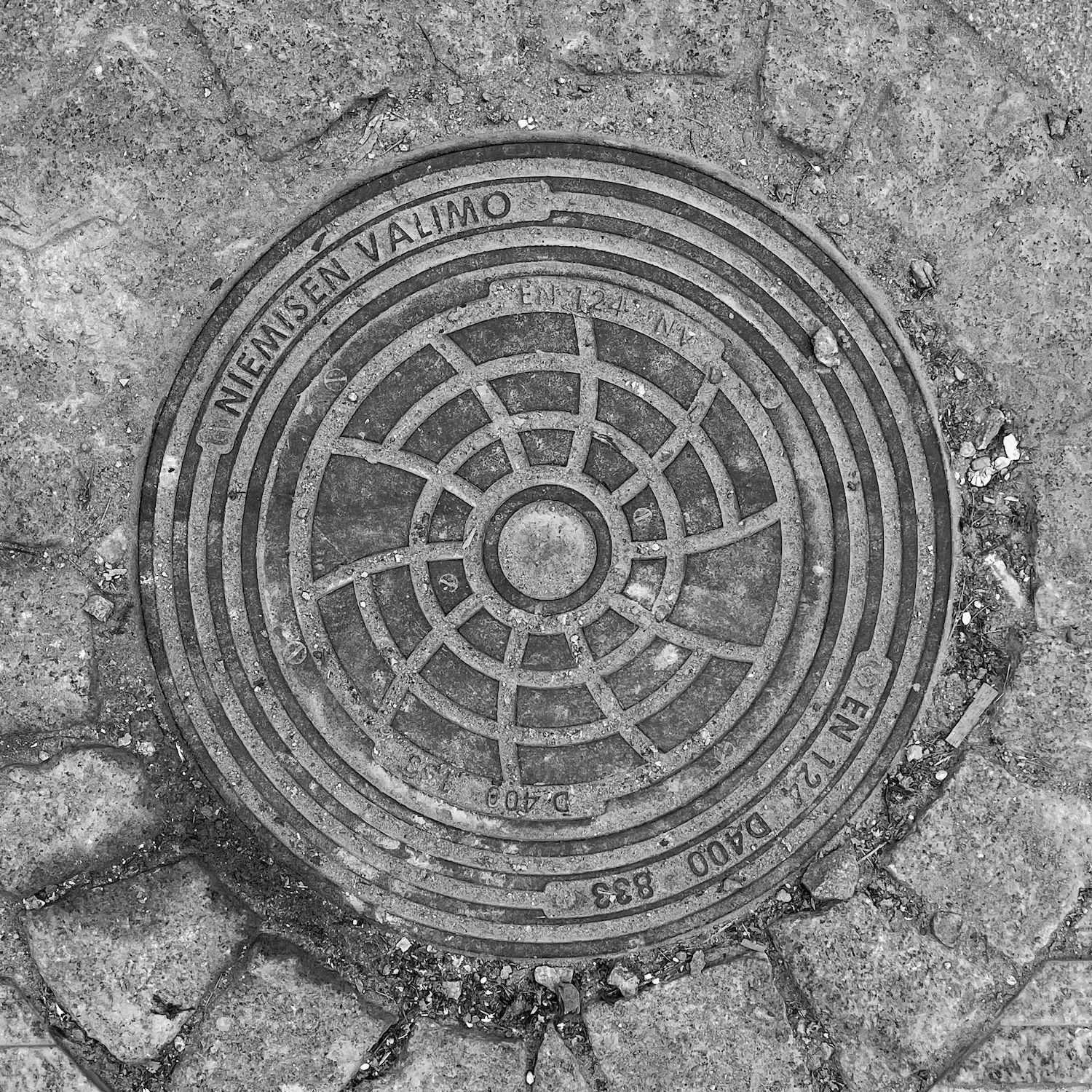 black and white image of a utility cover