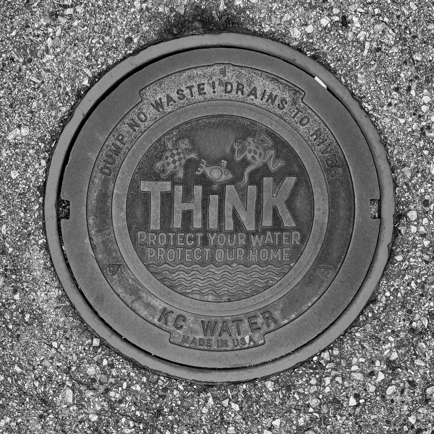 black and white image of a utility cover