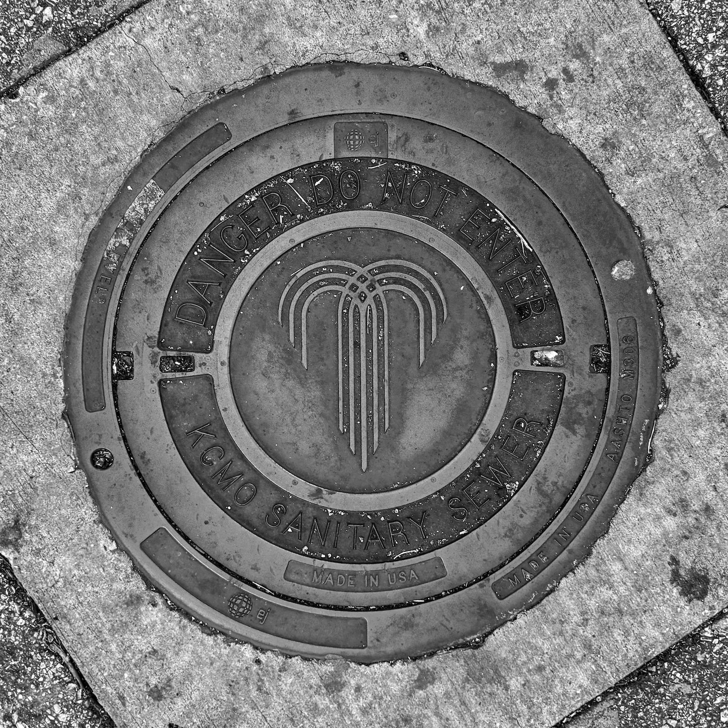 black and white image of a utility cover
