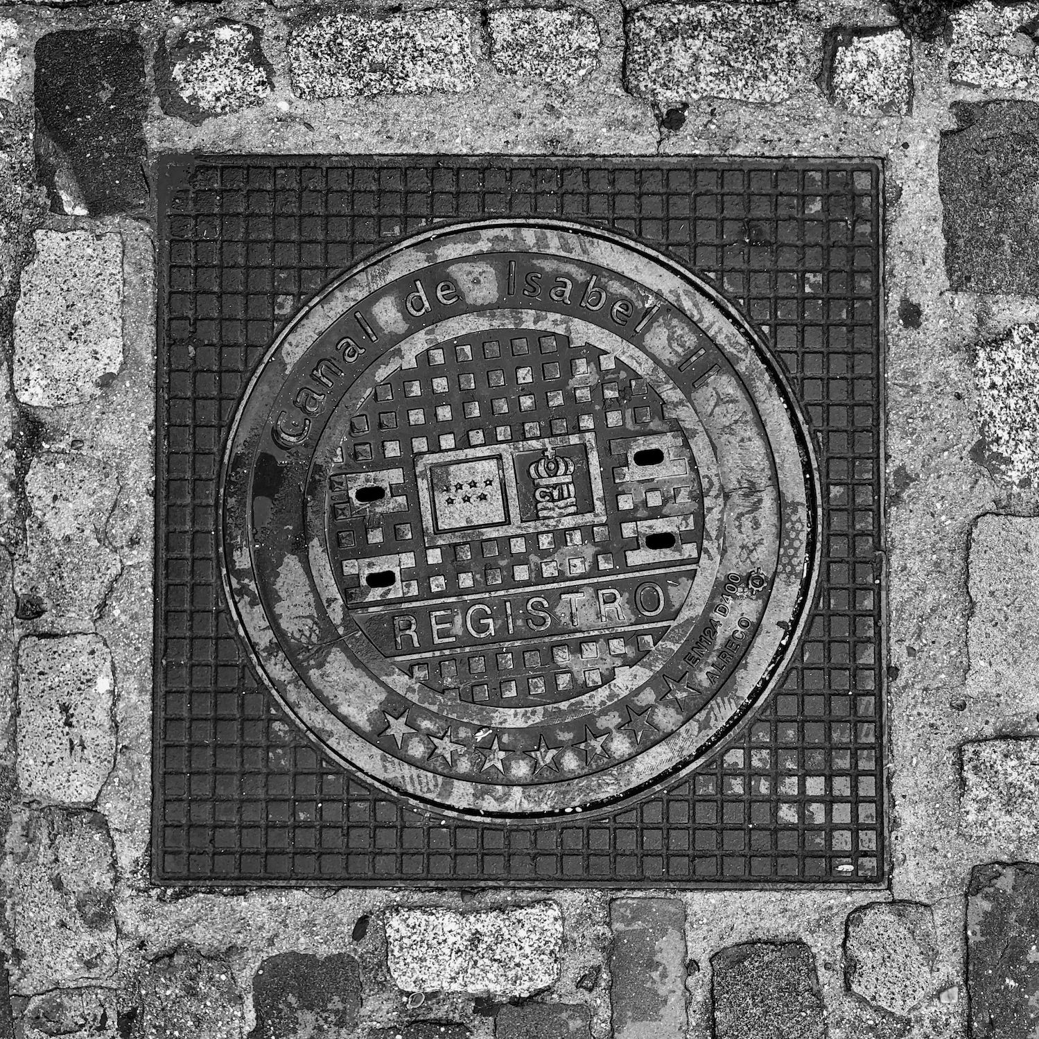 black and white image of a utility cover